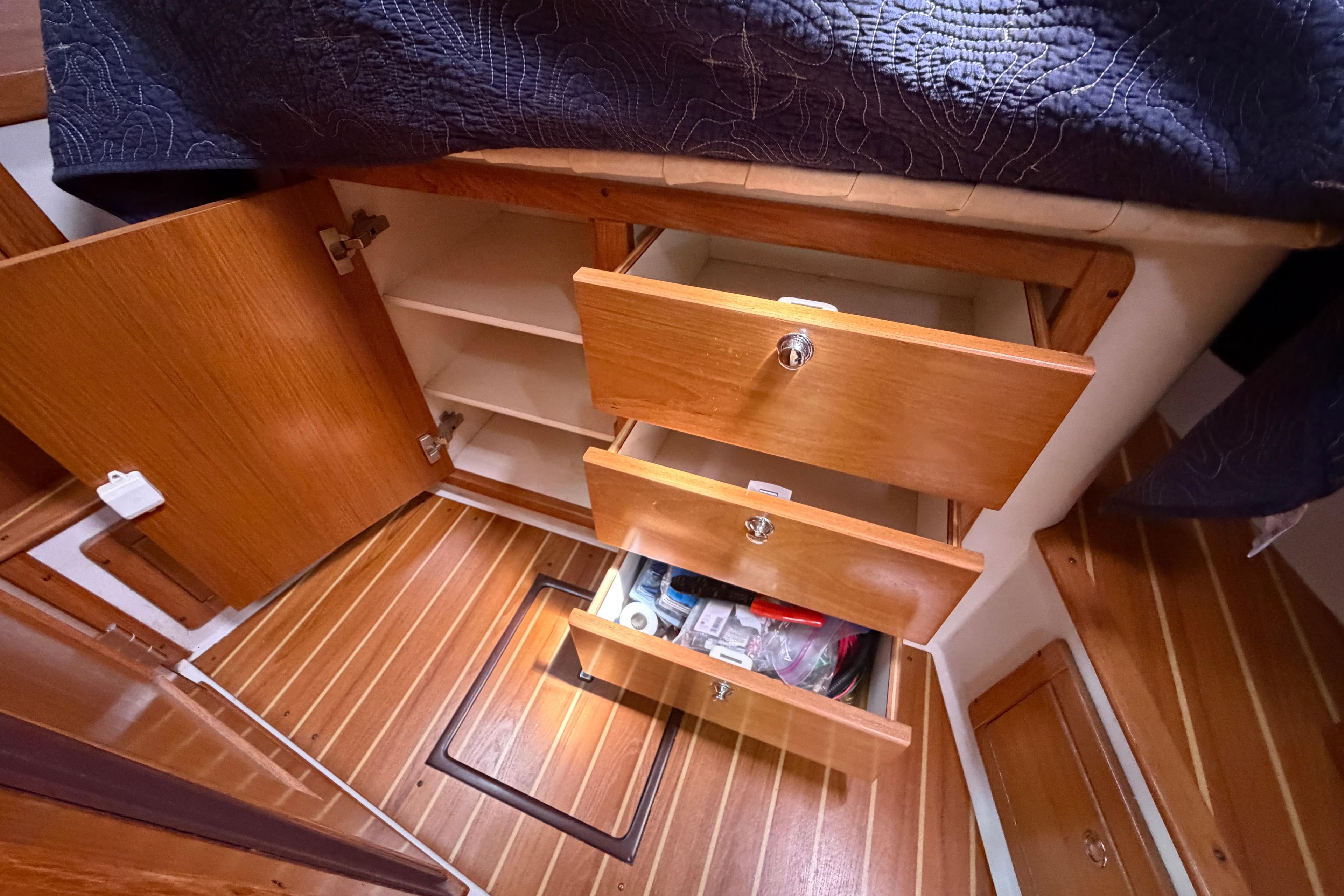 Interior storage of 2004 Catalina 350 sailboat with open drawers and cabinets.