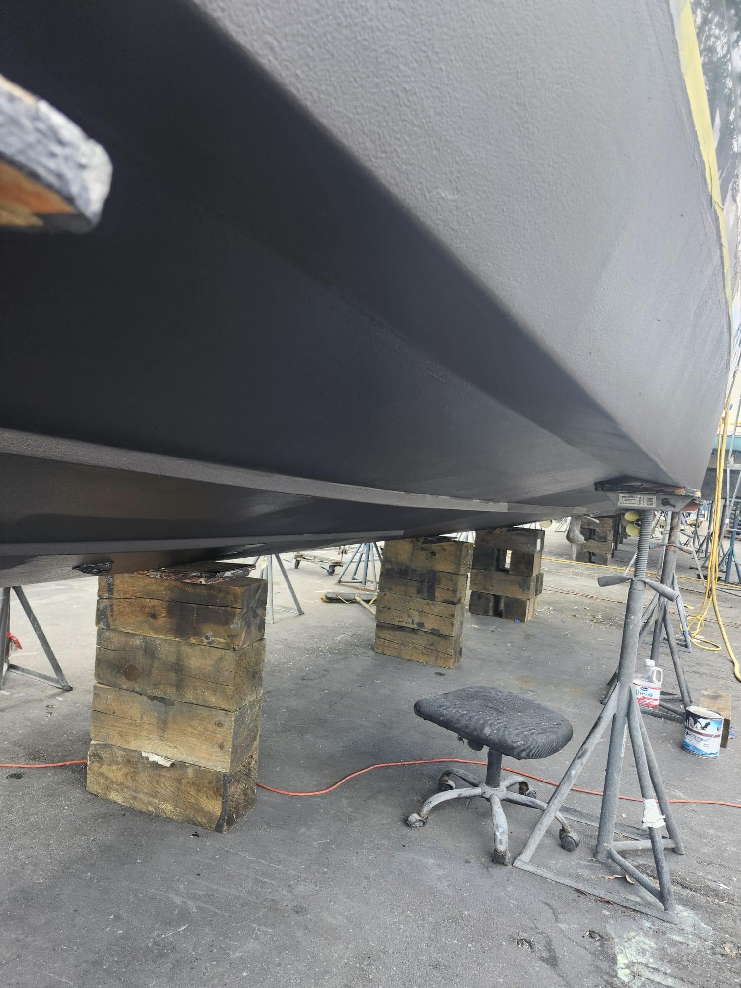 2022 Evolve 400HT boat hull on blocks in a maintenance area.
