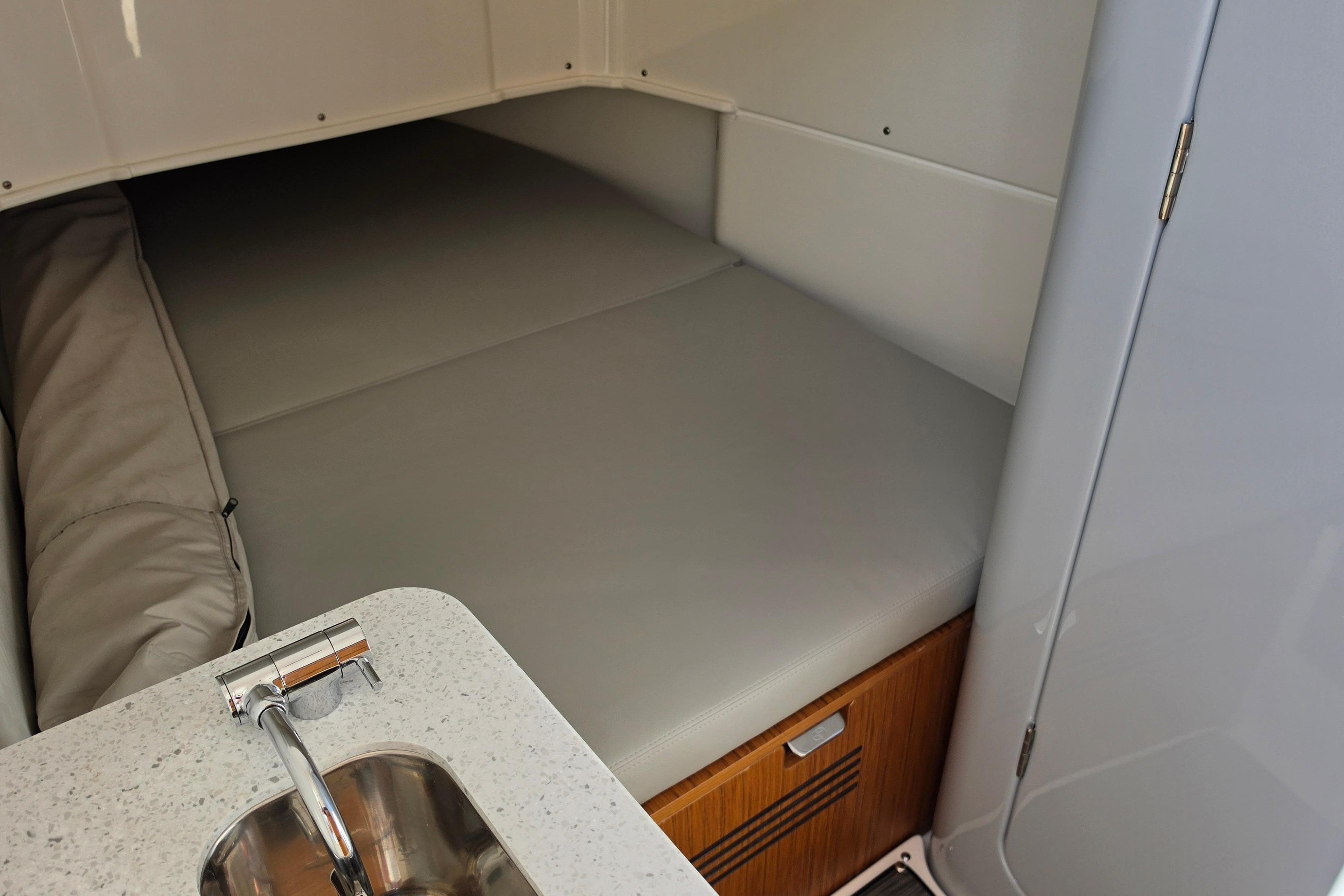 Interior cabin of 2026 Solace 35CS boat with bed and sink.