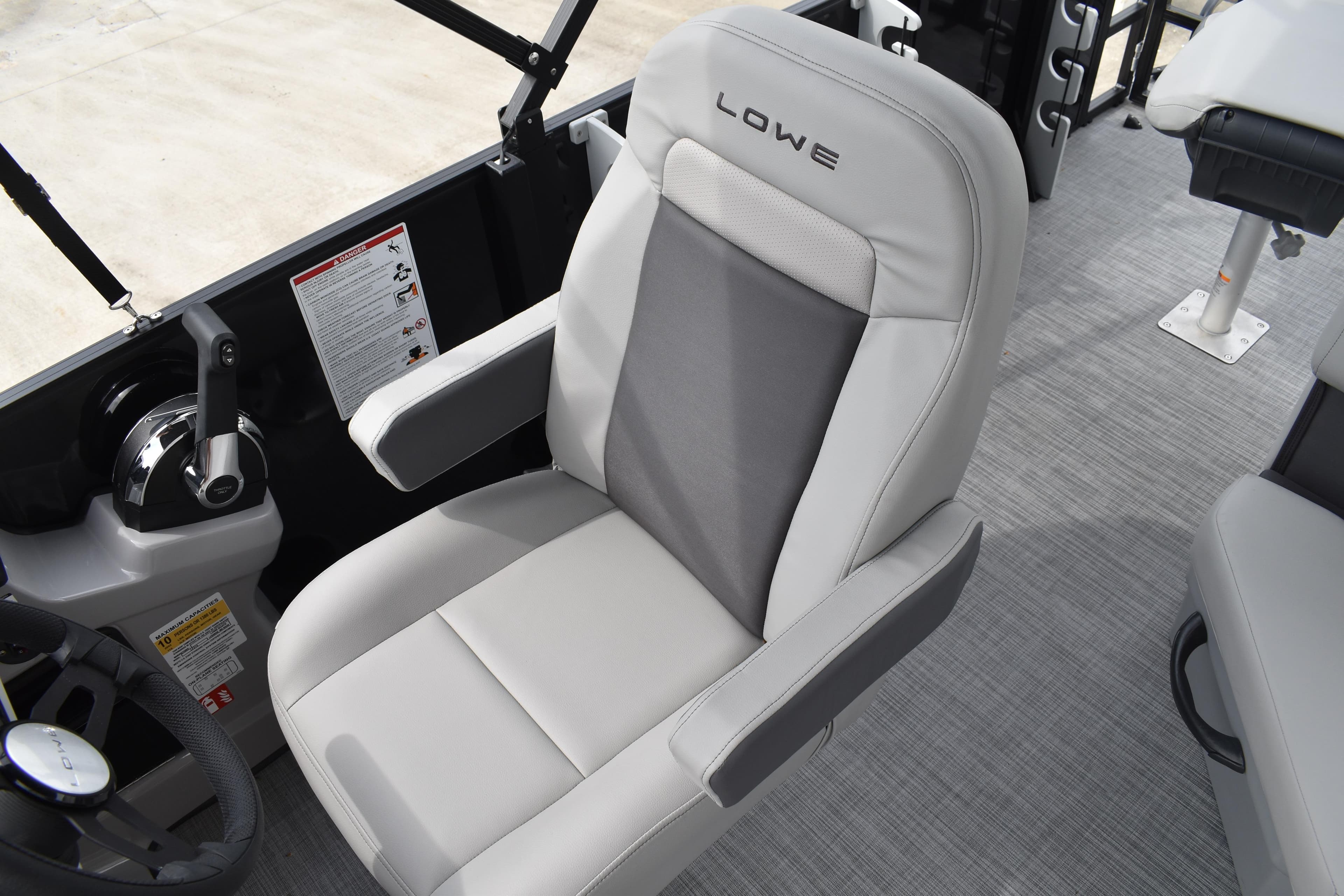 2026 Lowe LF 214 boat interior with comfortable seating and control panel.