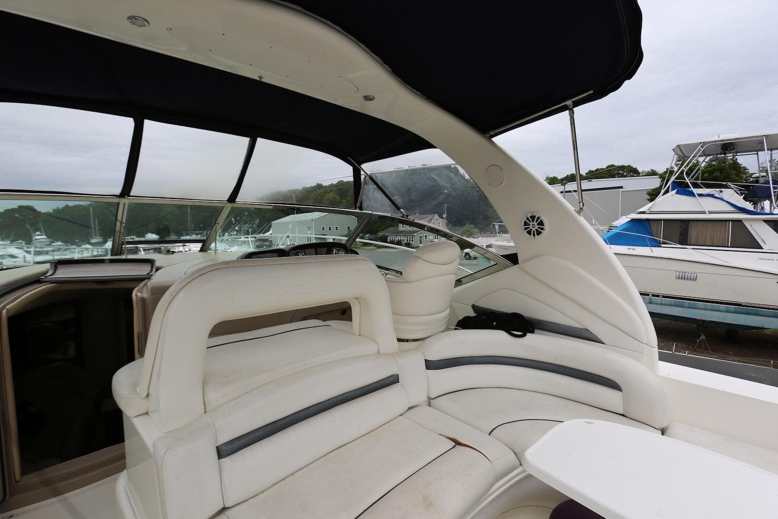 2003 Sea Ray 420 Sundancer interior with white seating and marina view.