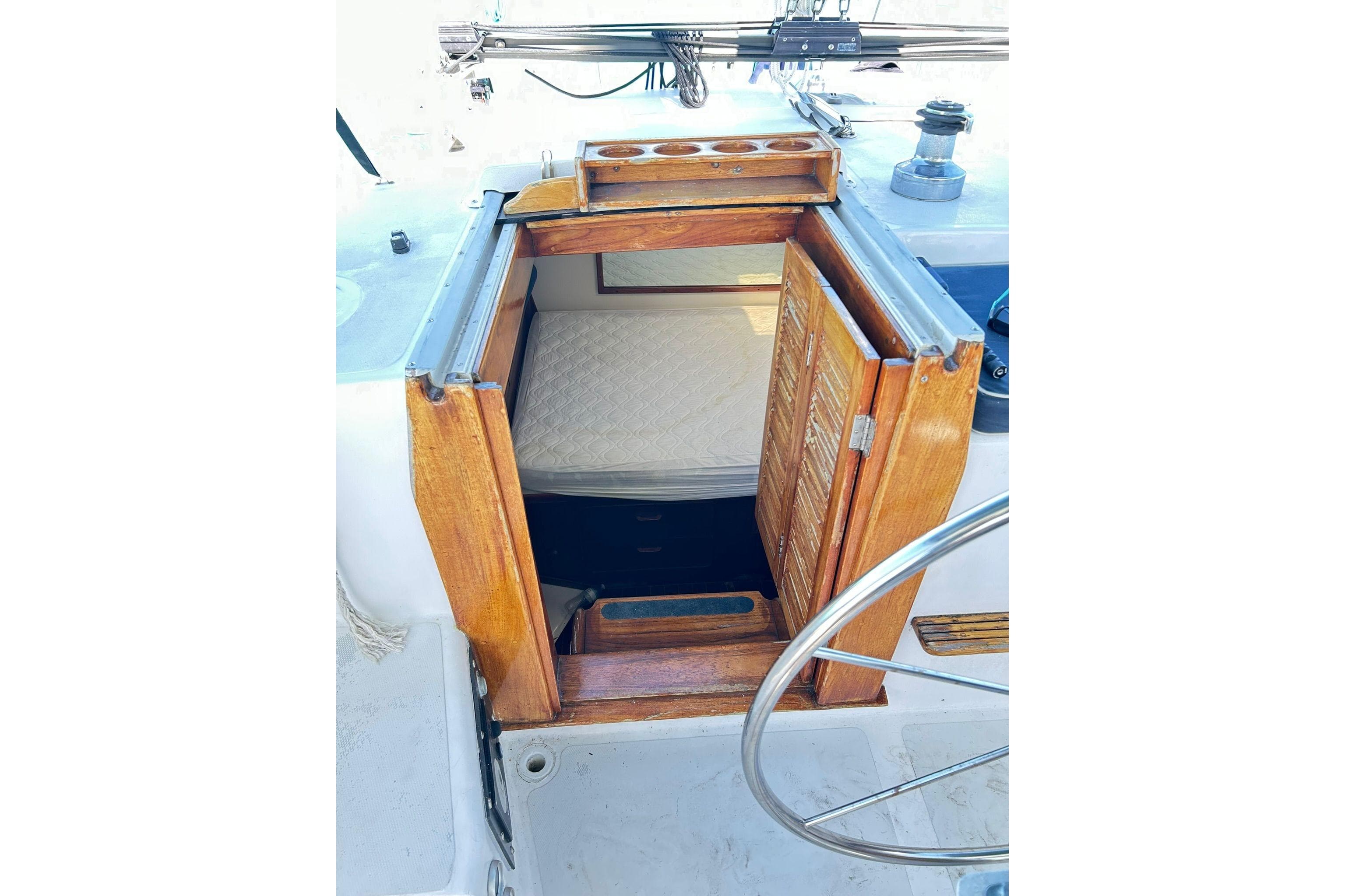 1987 Gulfstar CSY 50 Pilot House cabin entrance with wooden doors and visible mattress.