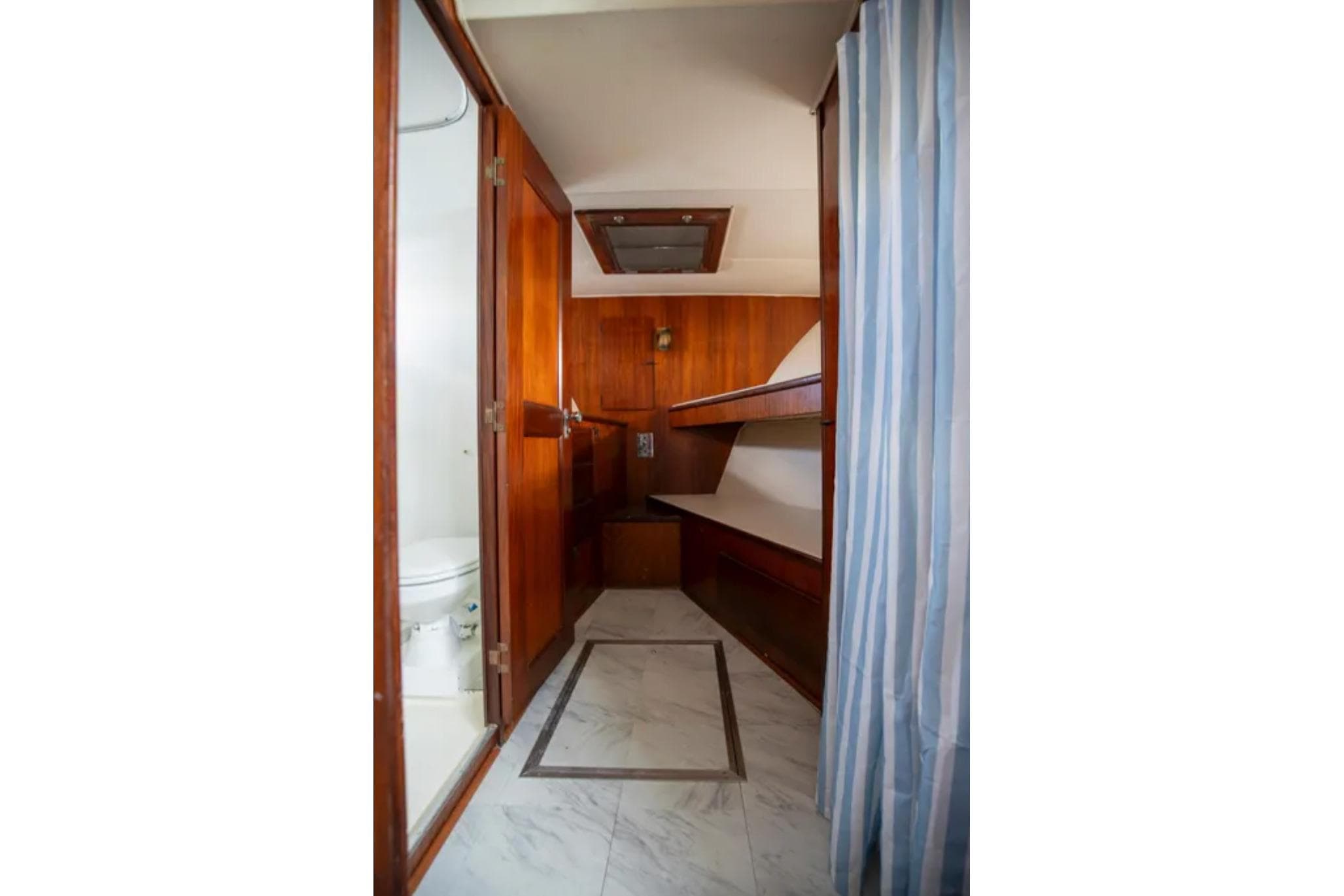 1973 Hatteras 58 Yacht Fisherman interior with wood paneling and bunk beds.