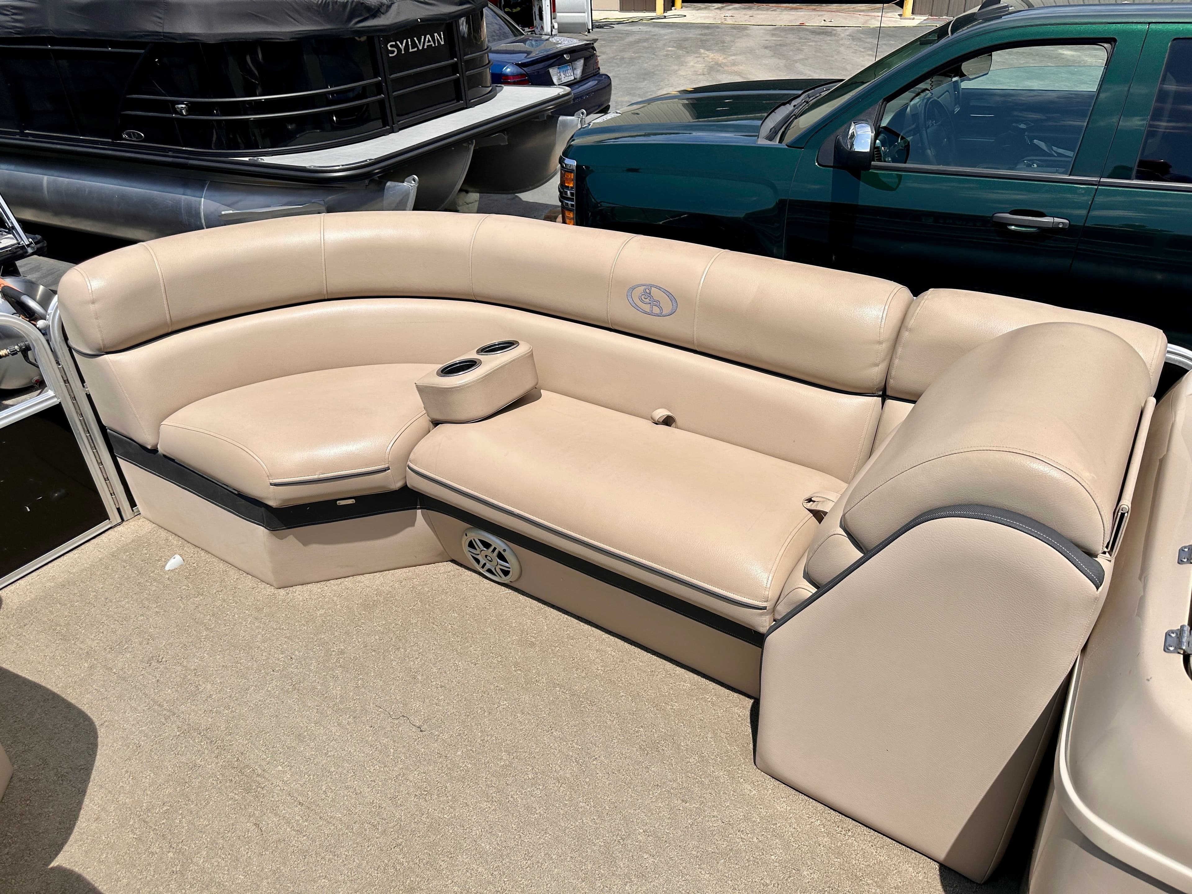 Beige leather seating on a 2015 South Bay 522 CR pontoon boat.