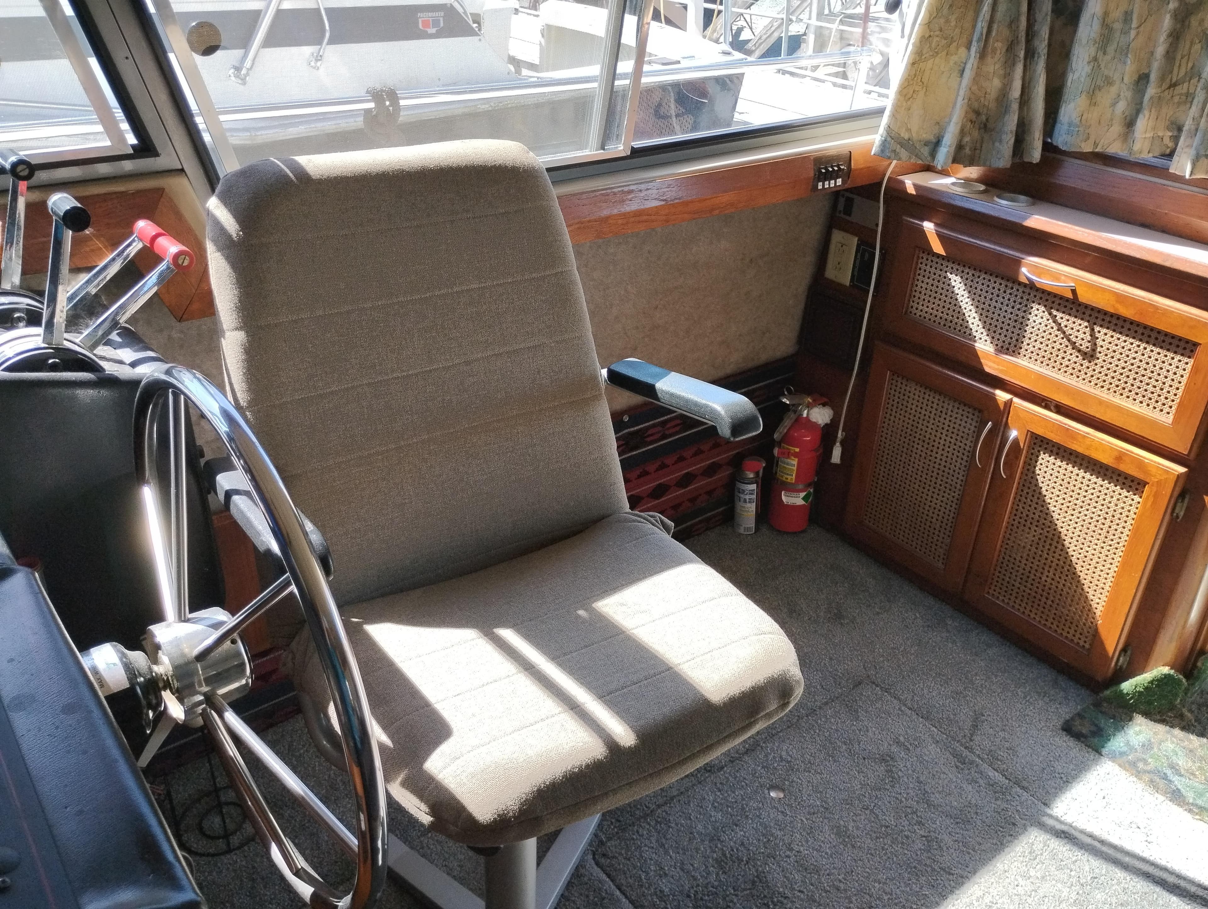 Interior of 1986 Bayliner 3870 Motoryacht helm with steering wheel and control panel.