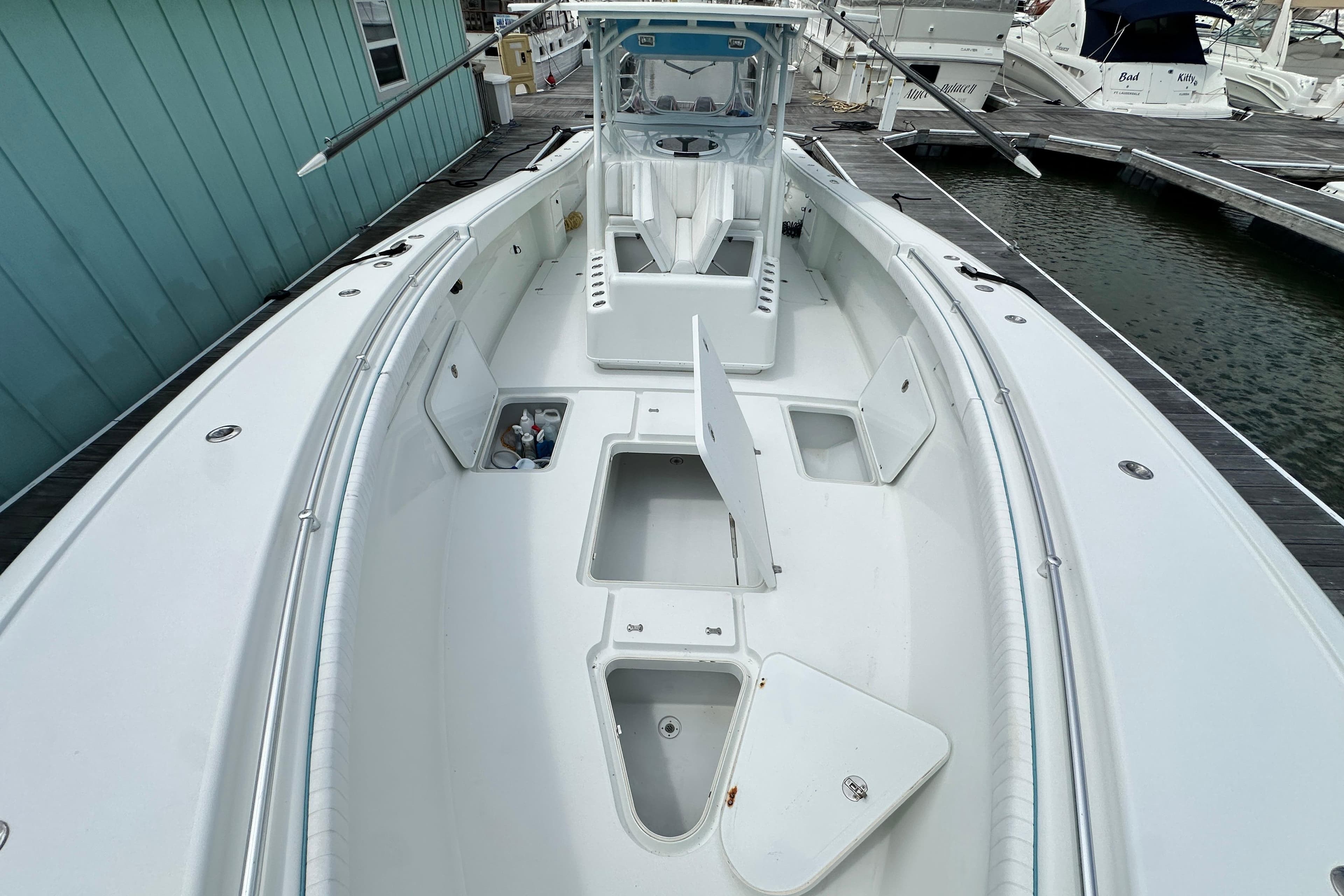 2009 Yellowfin 42 Offshore boat docked, showcasing spacious deck and storage compartments.