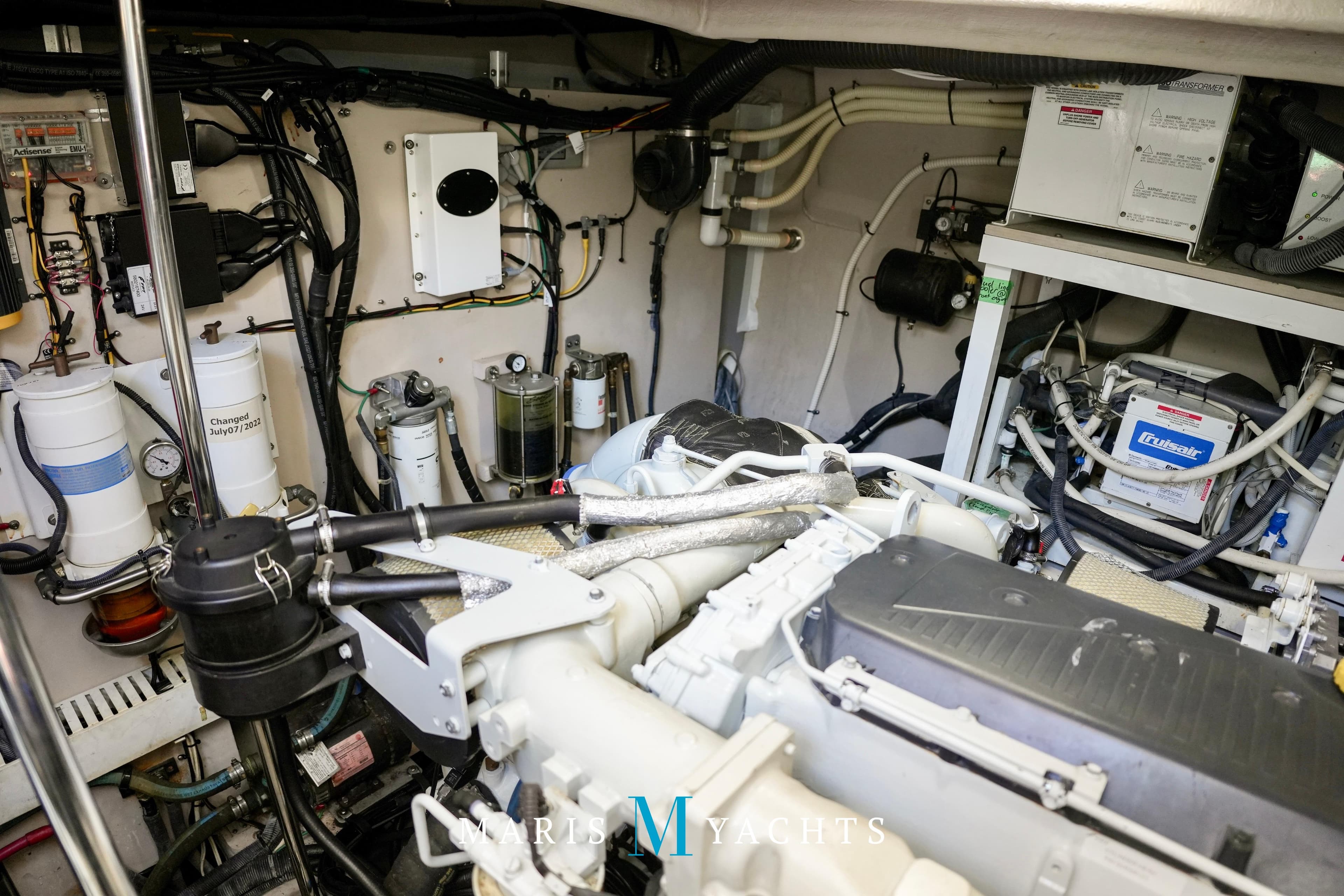Engine room of 2009 Sea Ray 55 Sundancer yacht, showcasing mechanical components and wiring.