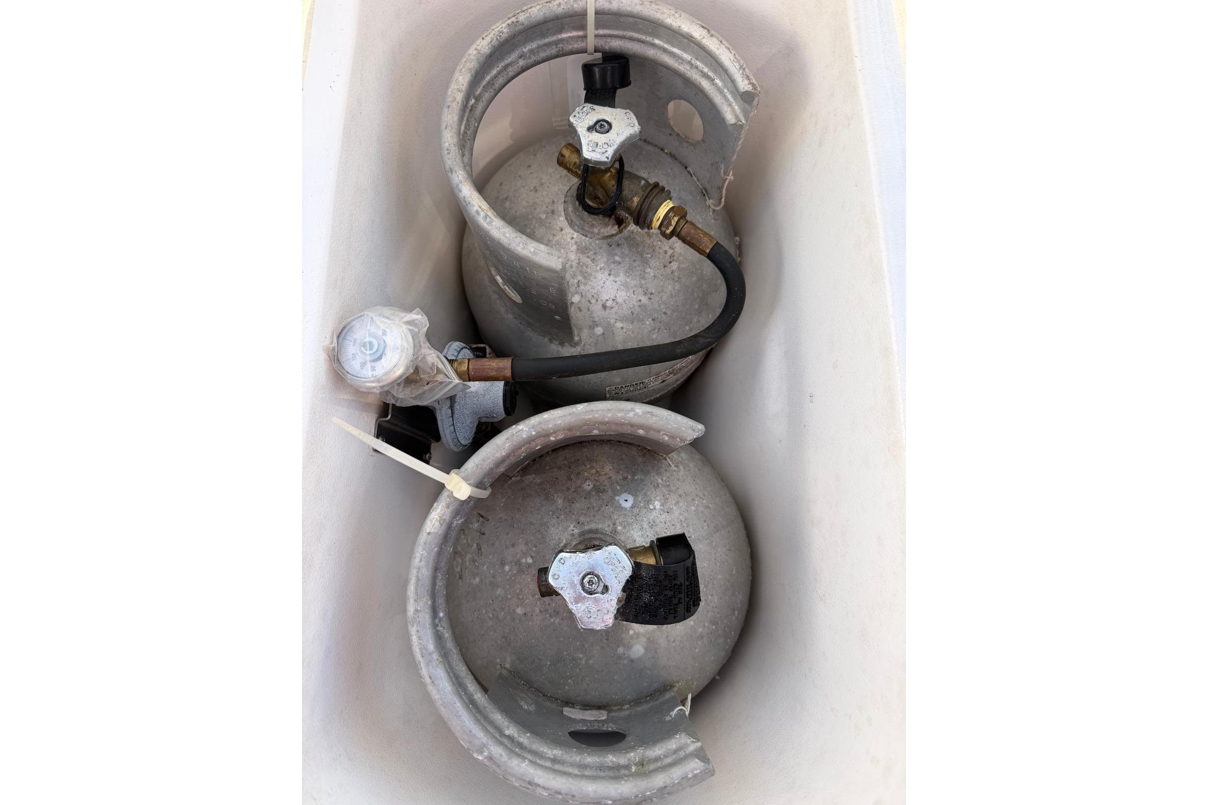 Two propane tanks in a storage compartment of a 2009 Hunter 50 Center Cockpit.