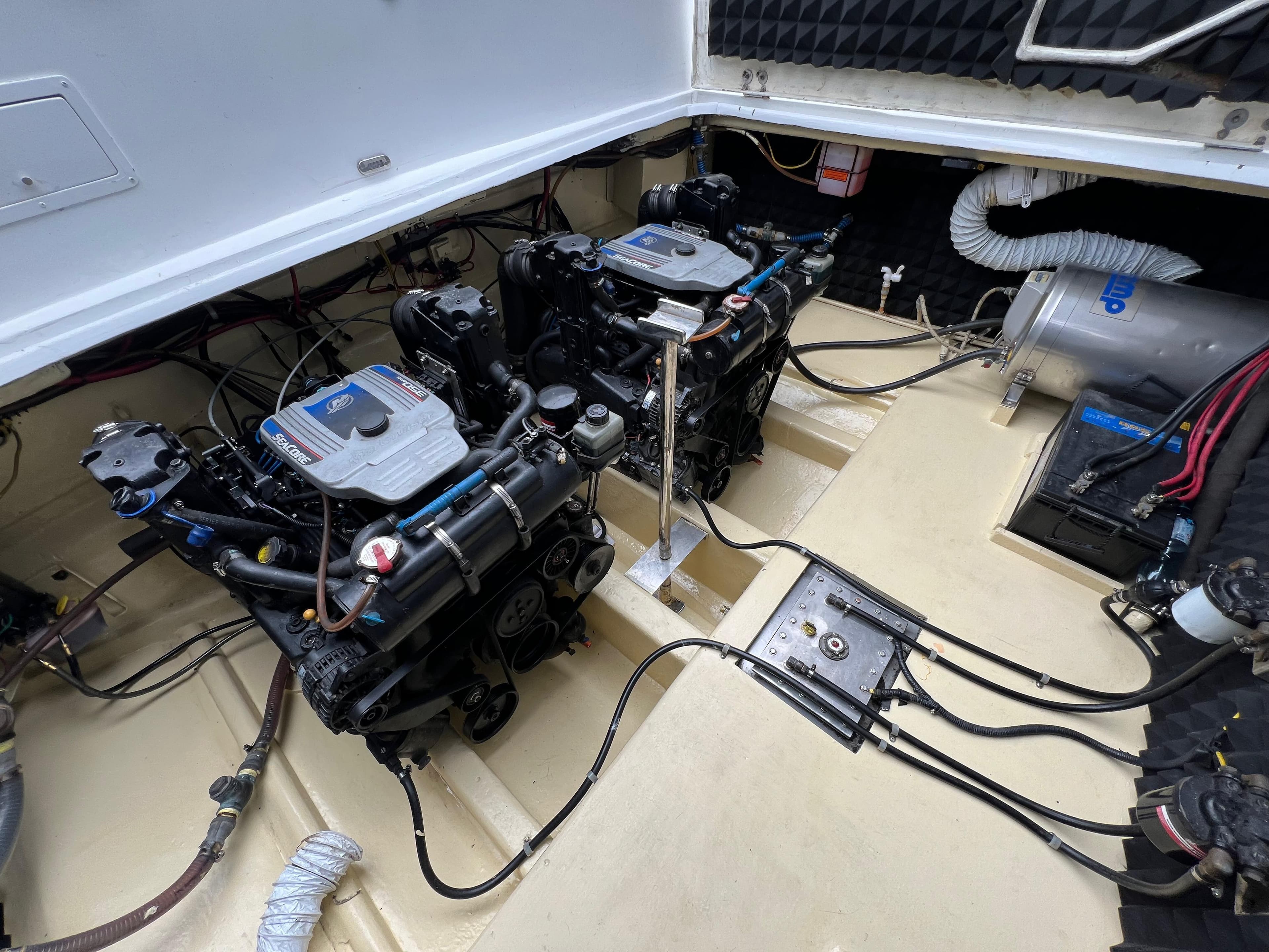 Engine compartment of a 1997 Custom 35 boat, featuring dual engines and mechanical components.