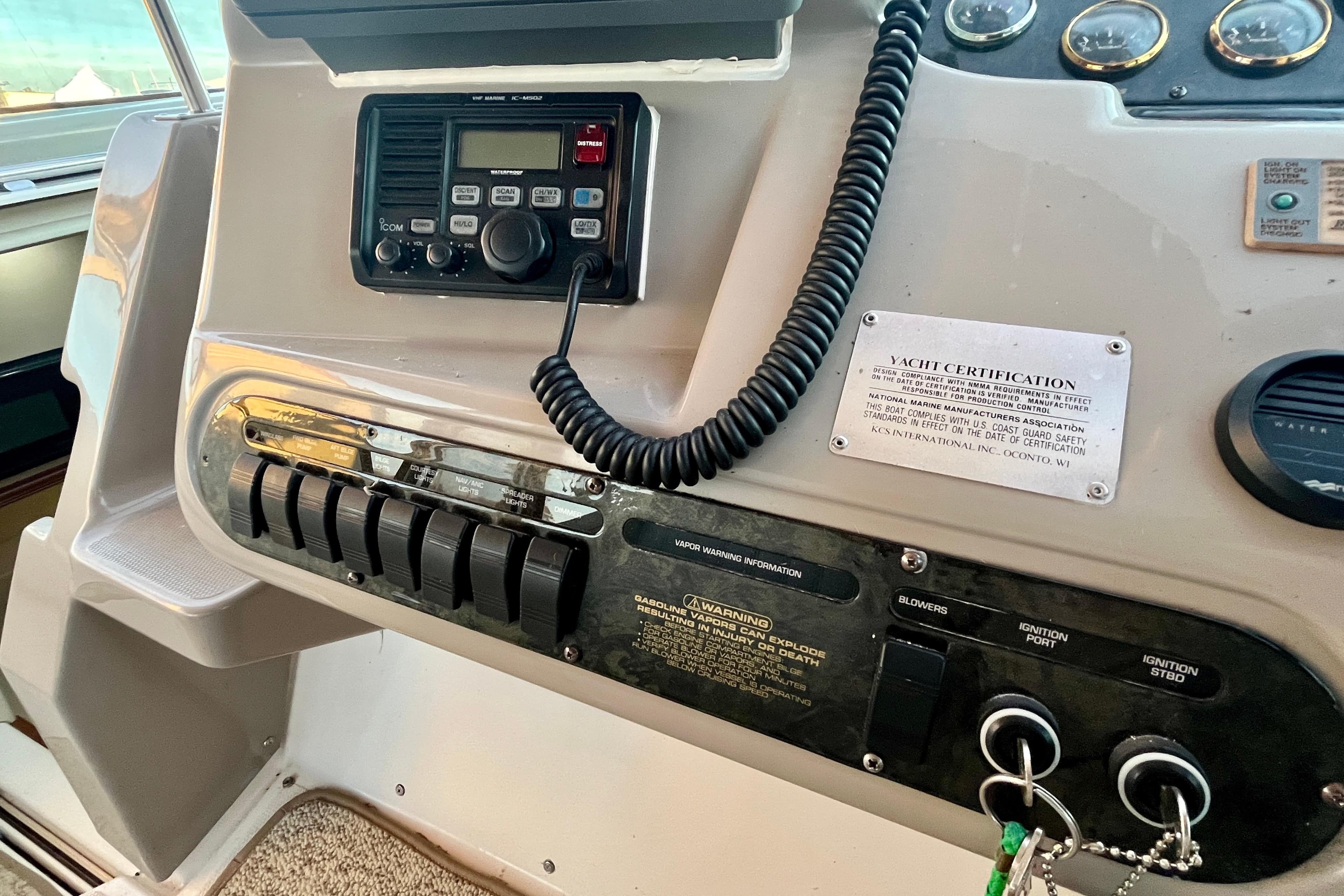 2001 Cruisers Yachts 3470 Express dashboard with radio, controls, and yacht certification plaque.