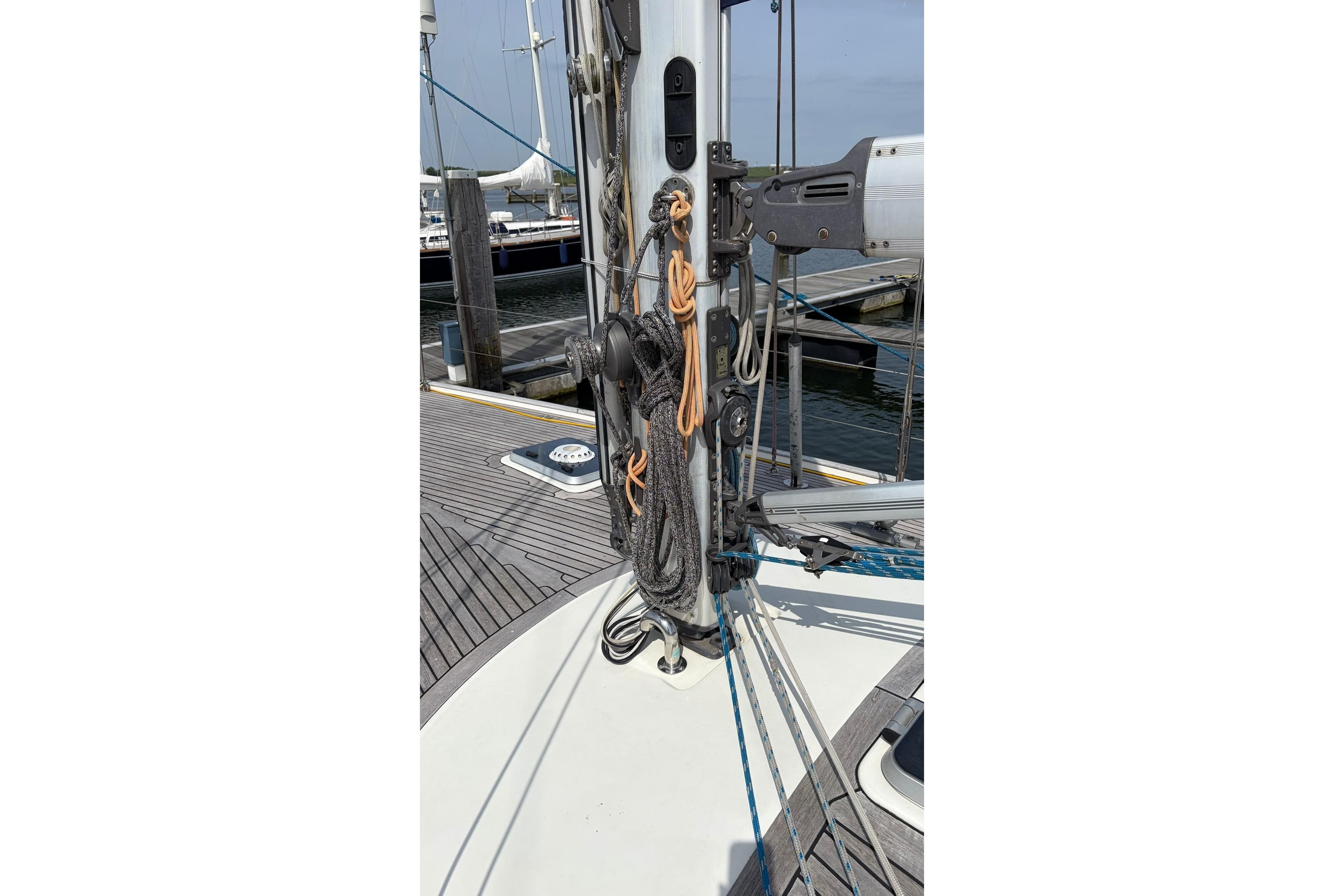 Sailboat mast with rigging and ropes, Contest 46-48, 1997 model, docked at marina.