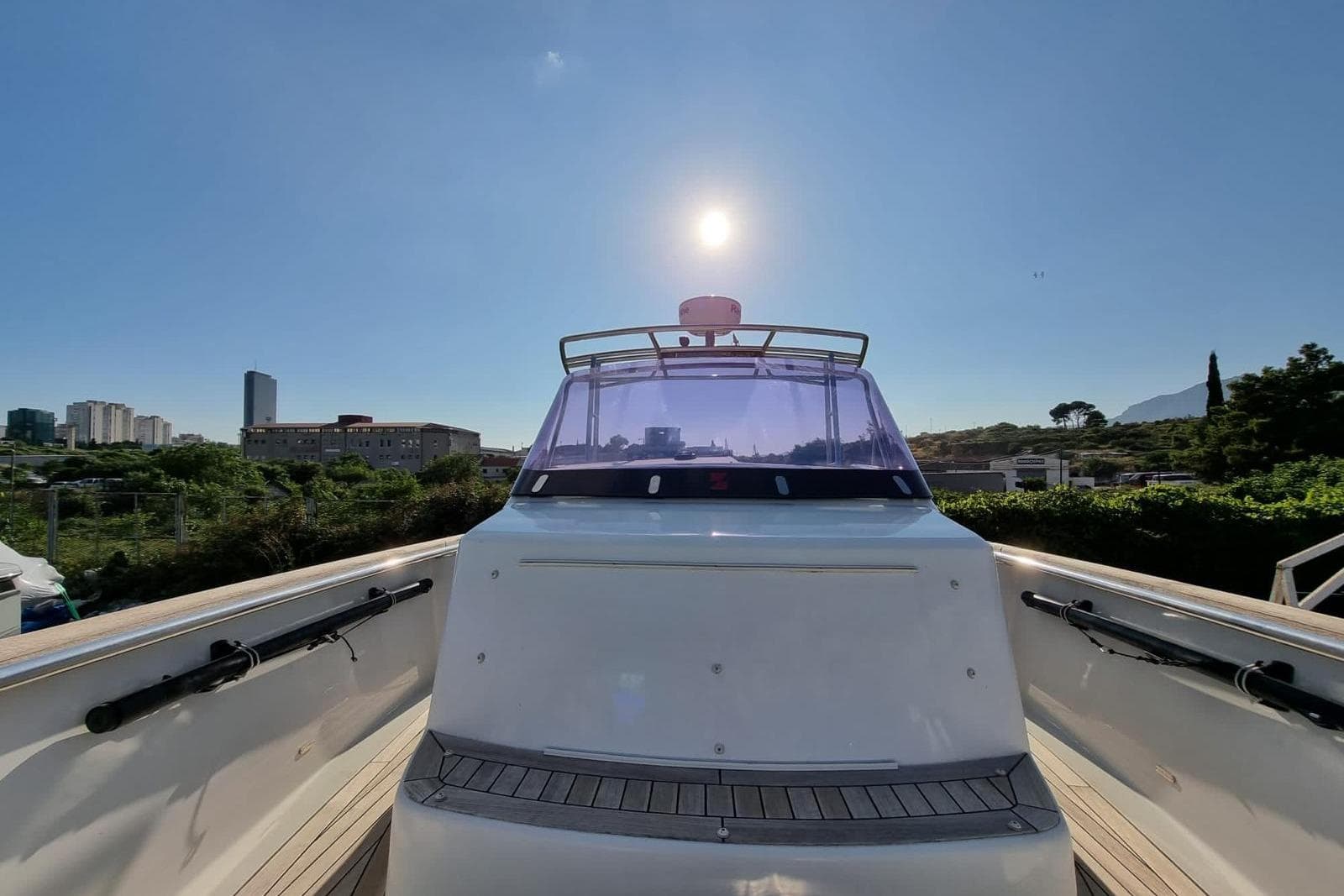 2015 Fjord 36' Open yacht under clear sky, cityscape in background.