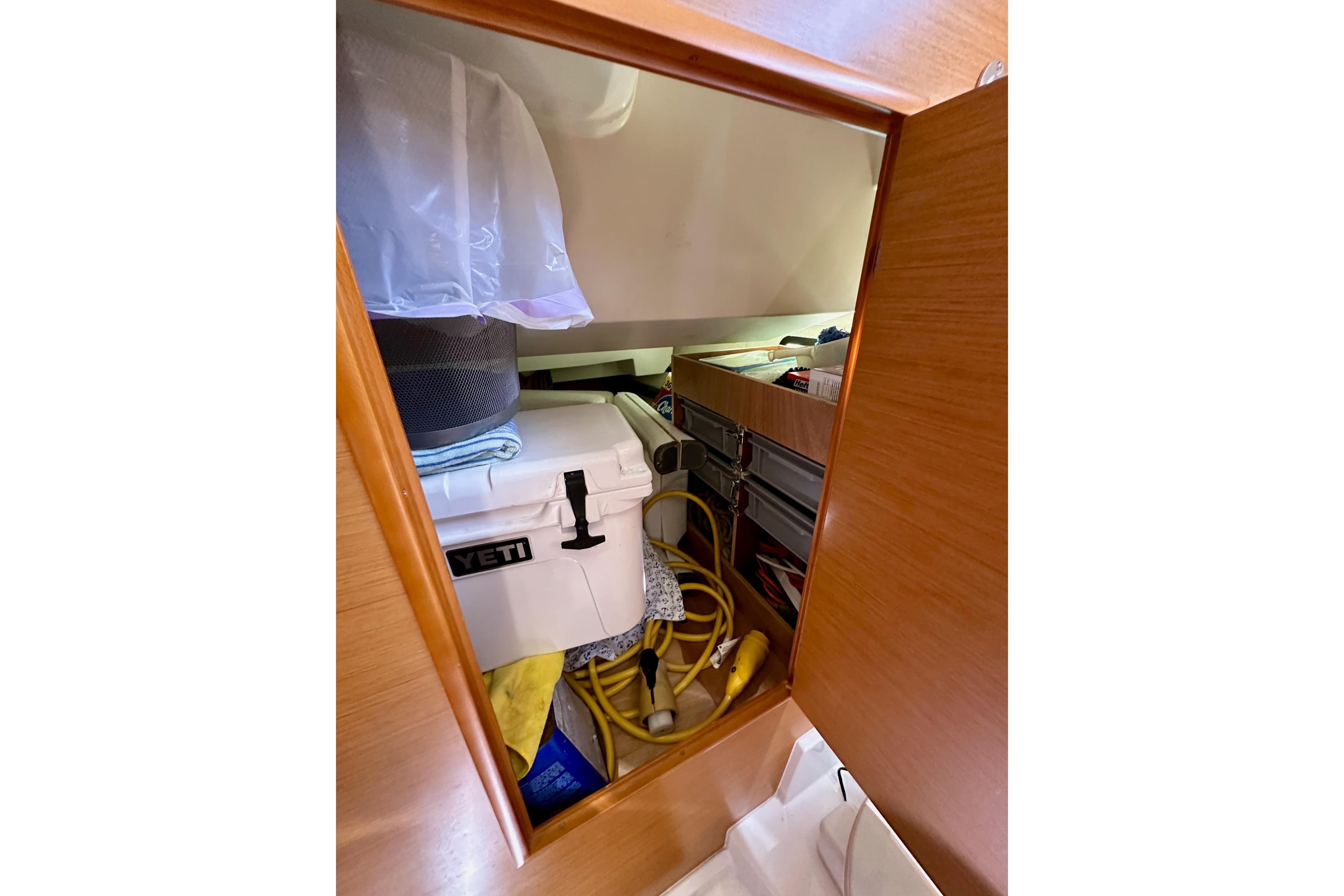 Storage compartment on 2015 Jeanneau Sun Odyssey 409 yacht with cooler and equipment.