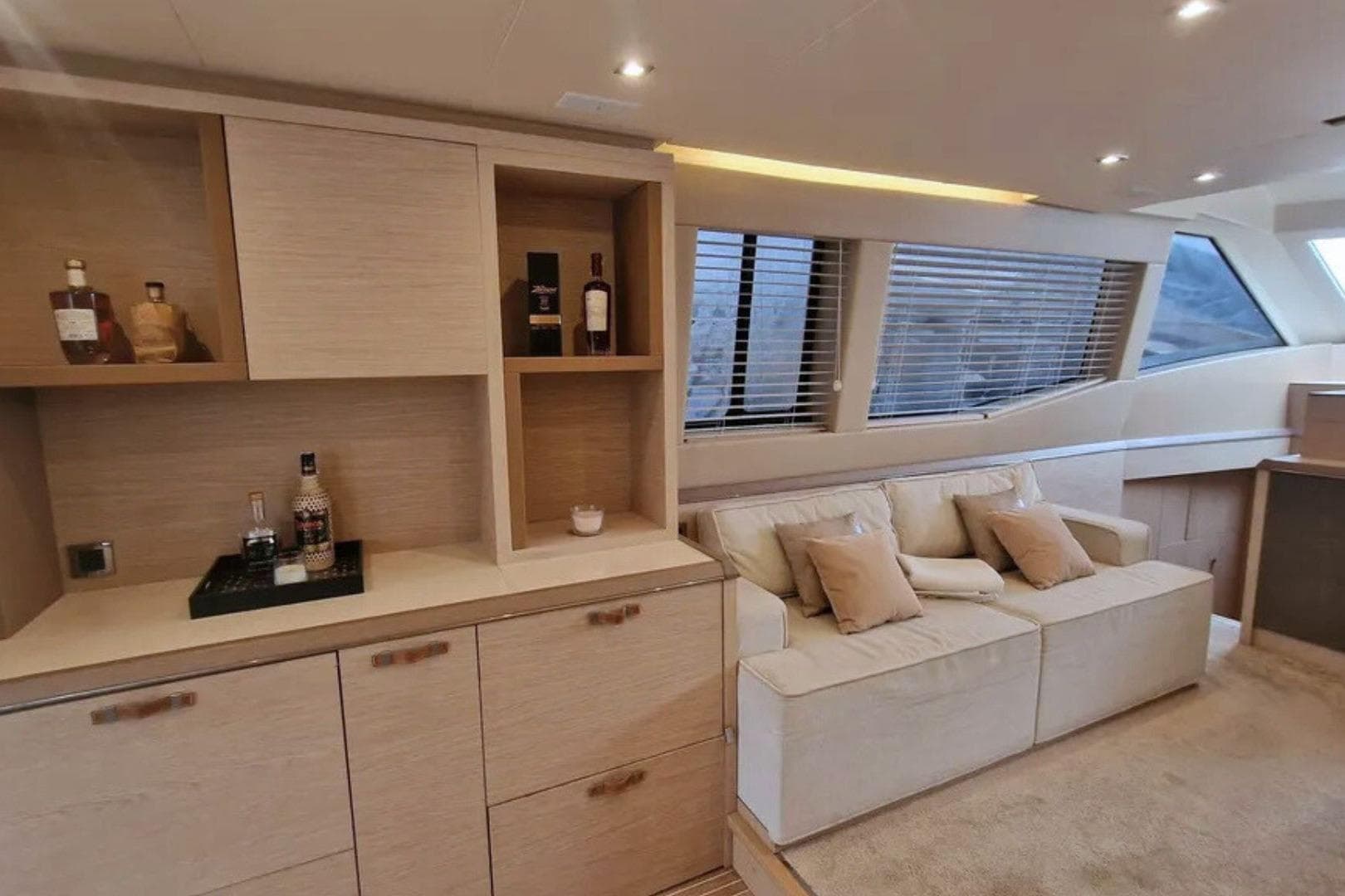 Luxurious interior of 2016 Beneteau Monte Carlo 6 yacht with cozy seating and elegant cabinetry.