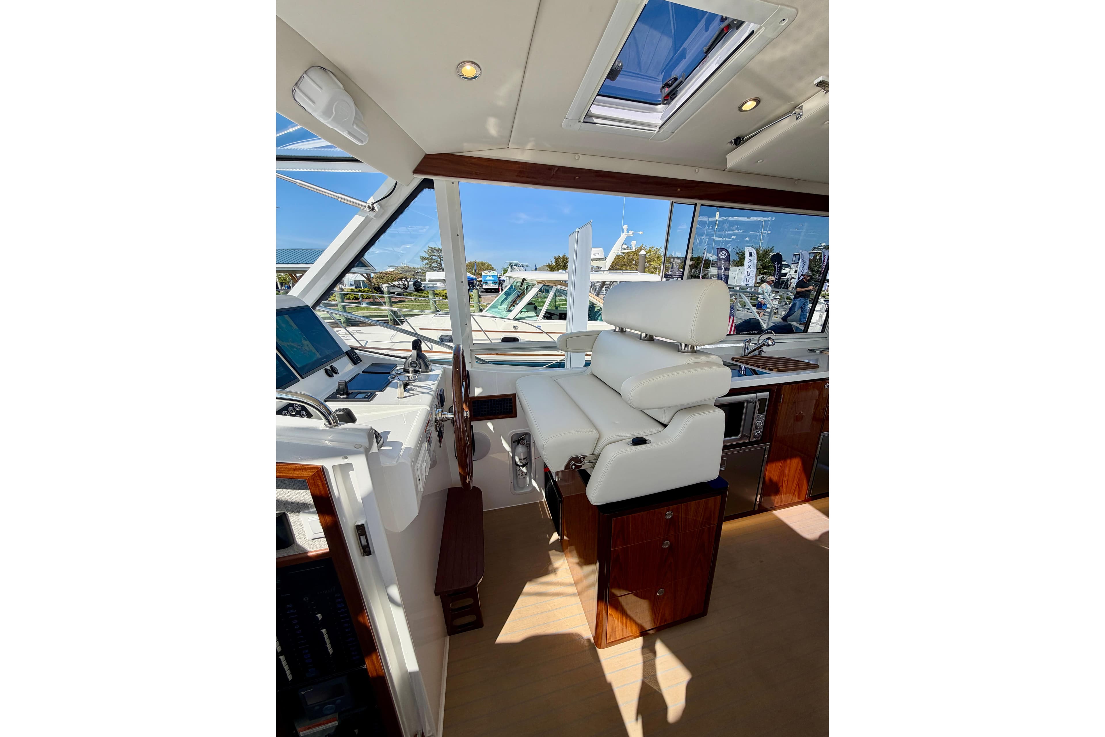 Luxurious interior of 2026 MJM 47 R yacht with plush seating and modern controls.