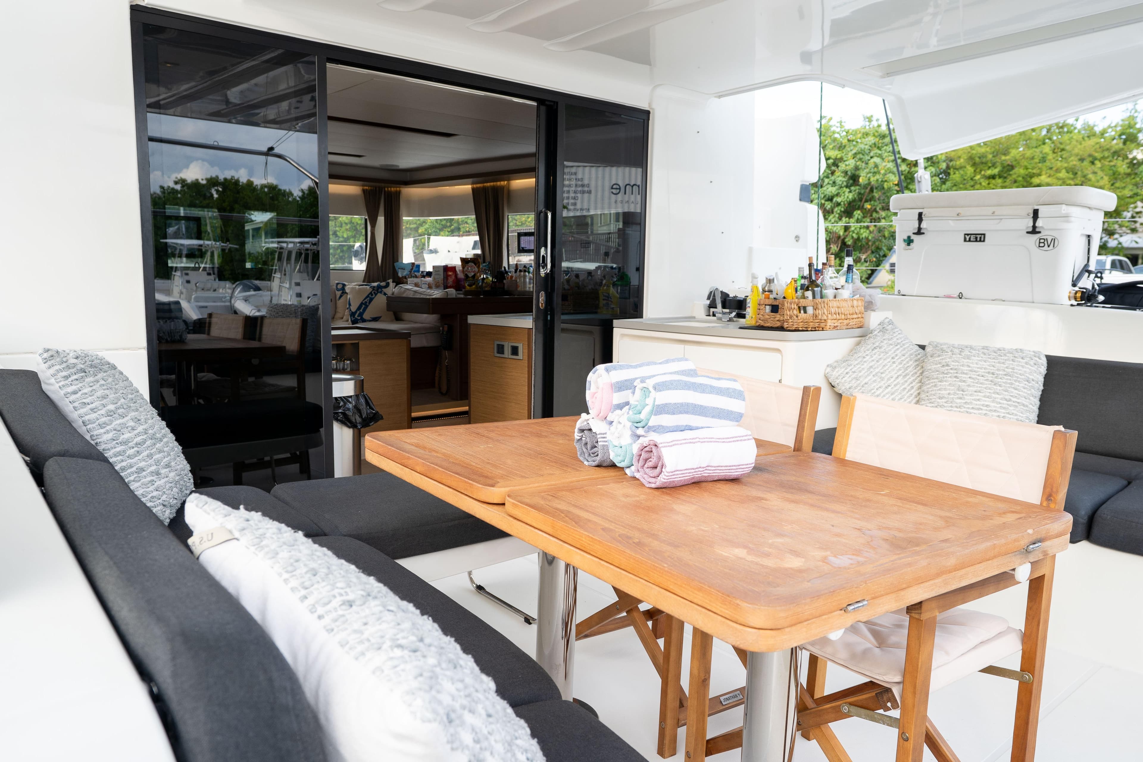 Luxurious Lagoon 50 yacht interior, featuring a cozy dining area with wooden table and plush seating.