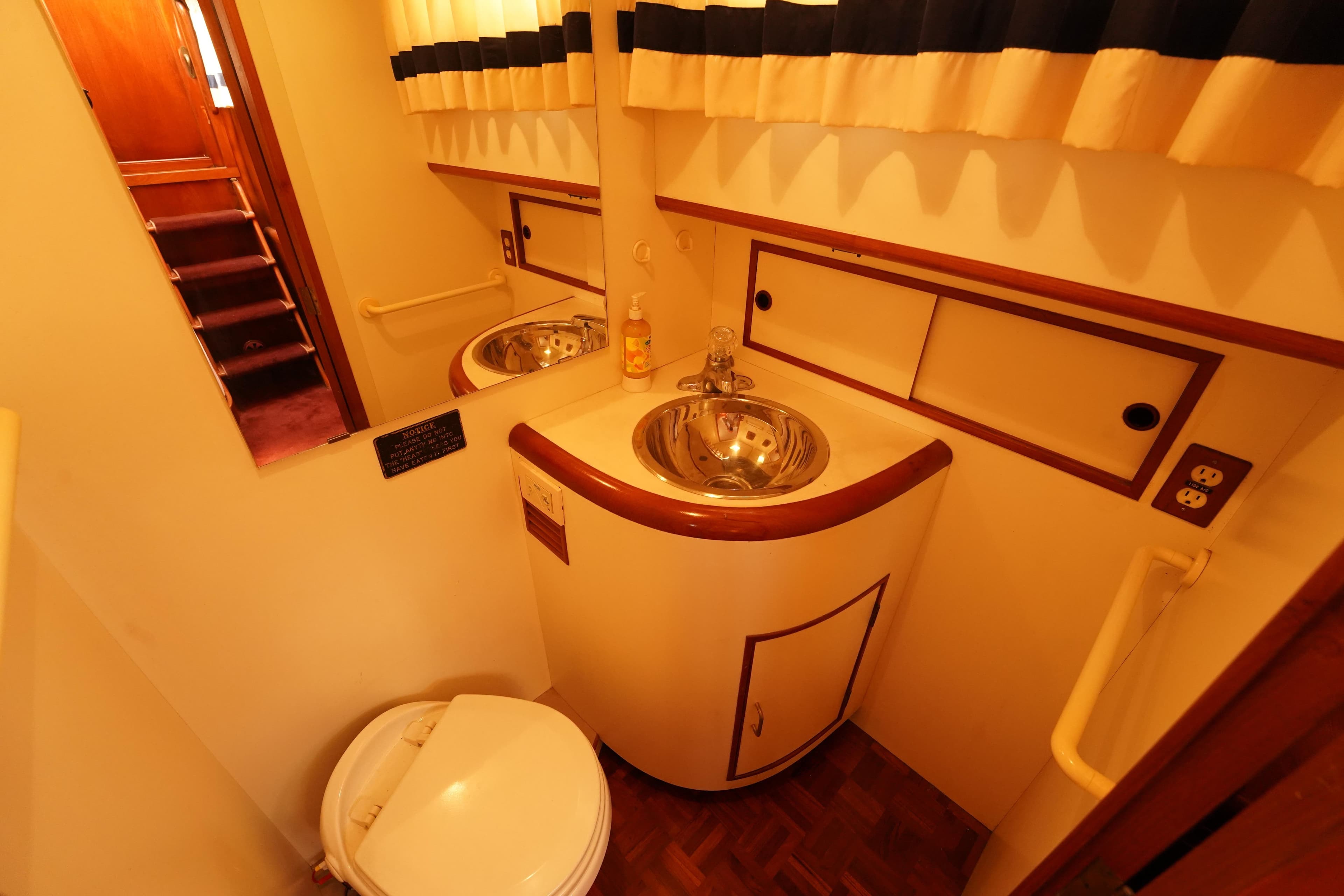 1986 Ocean Alexander 40 Double Cabin bathroom with sink, mirror, and toilet.