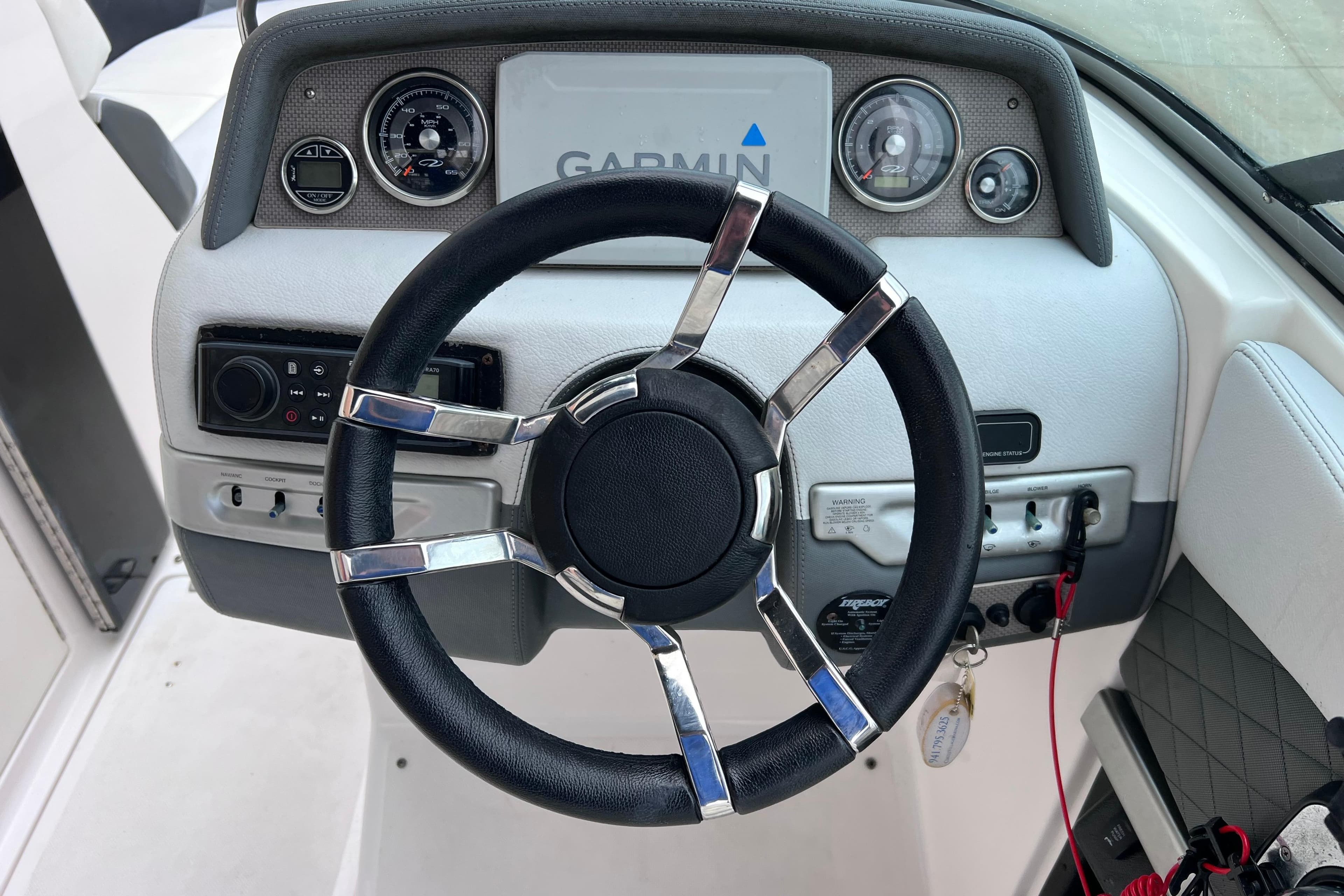 Steering wheel and dashboard of 2013 Regal 24 FasDeck RX boat with Garmin display.