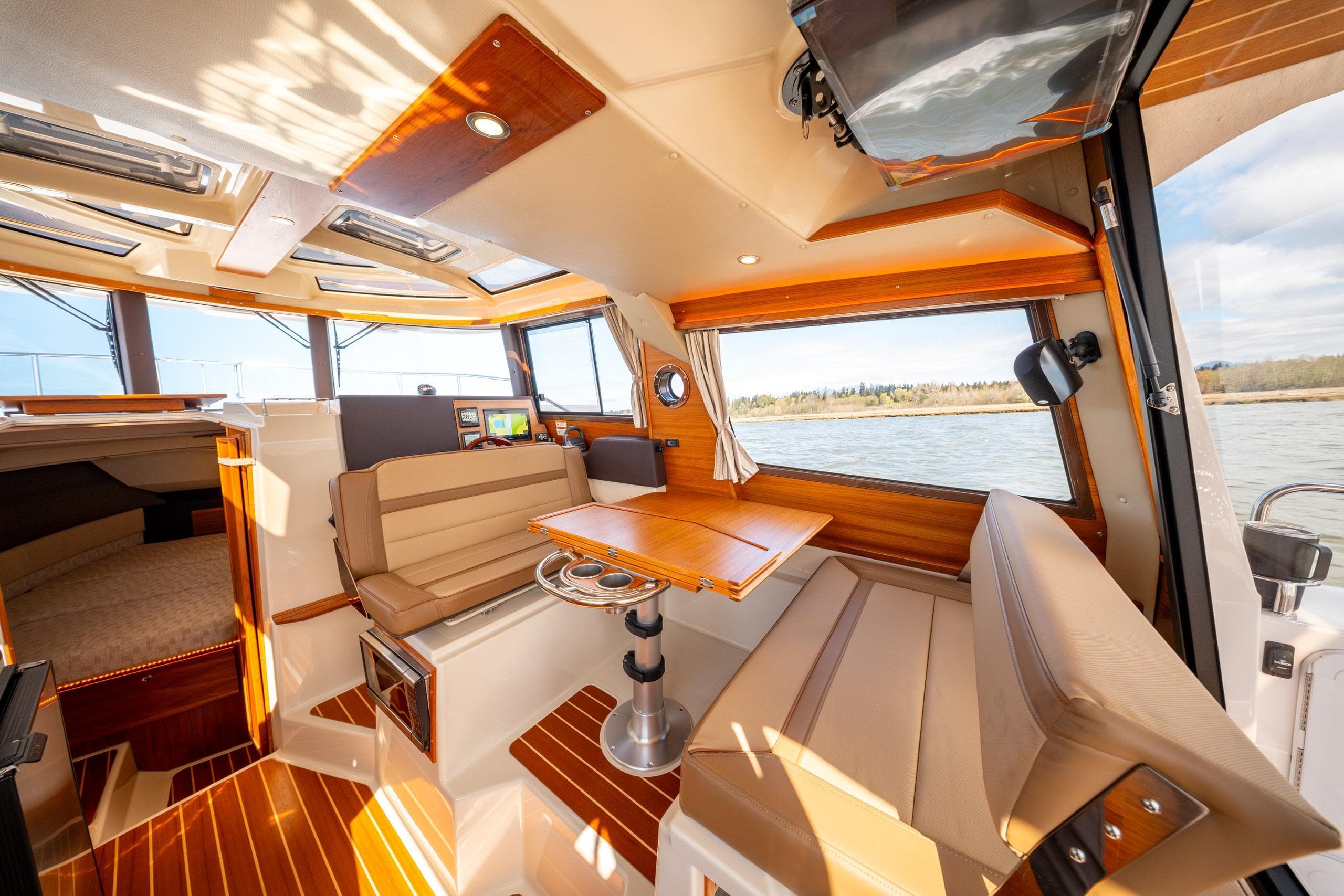 Interior of 2023 Ranger Tugs R-29 CB, featuring elegant seating and wood finishes.