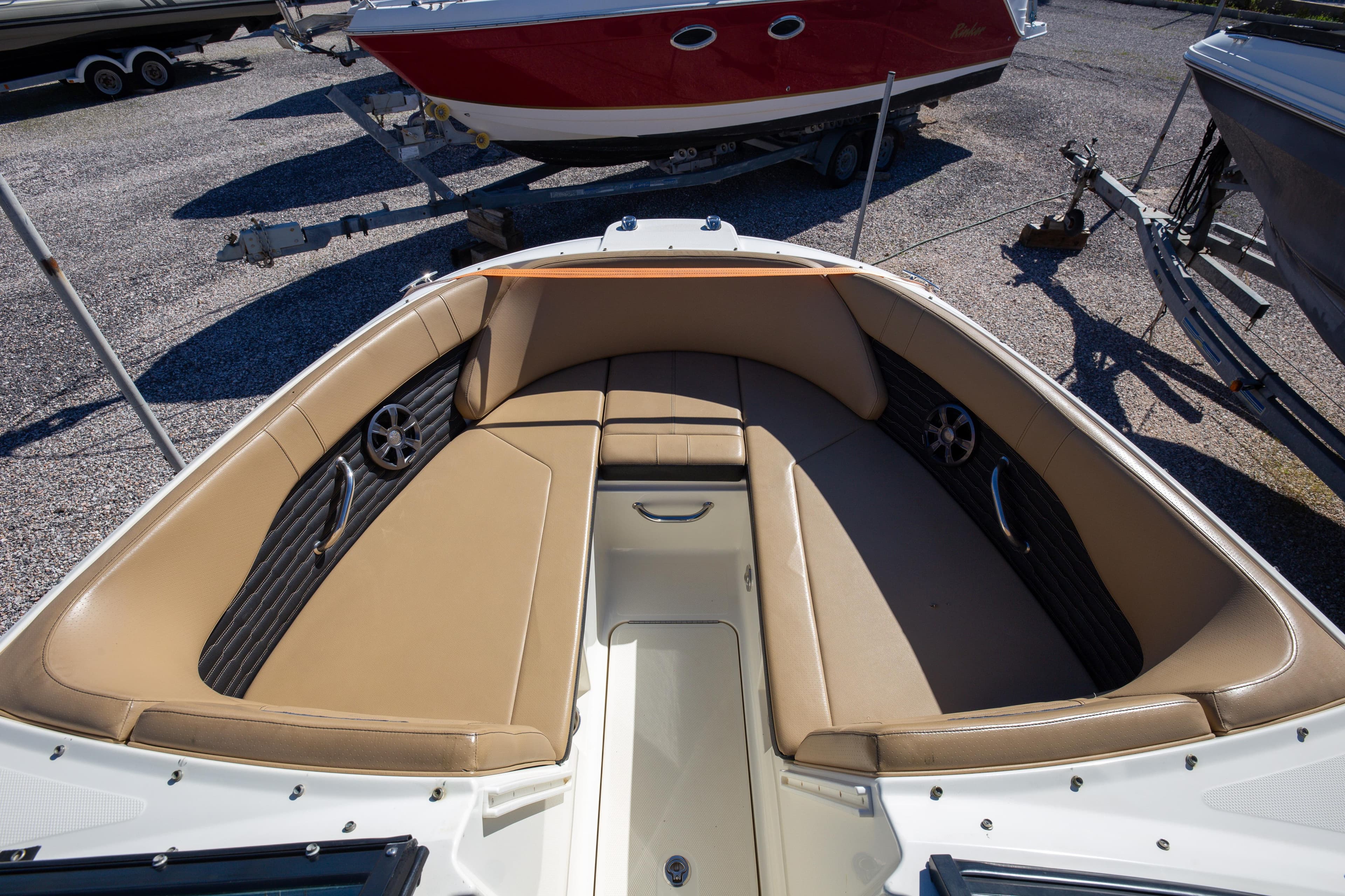 2021 Sea Ray SPX 230 boat interior with tan seating and sleek design.