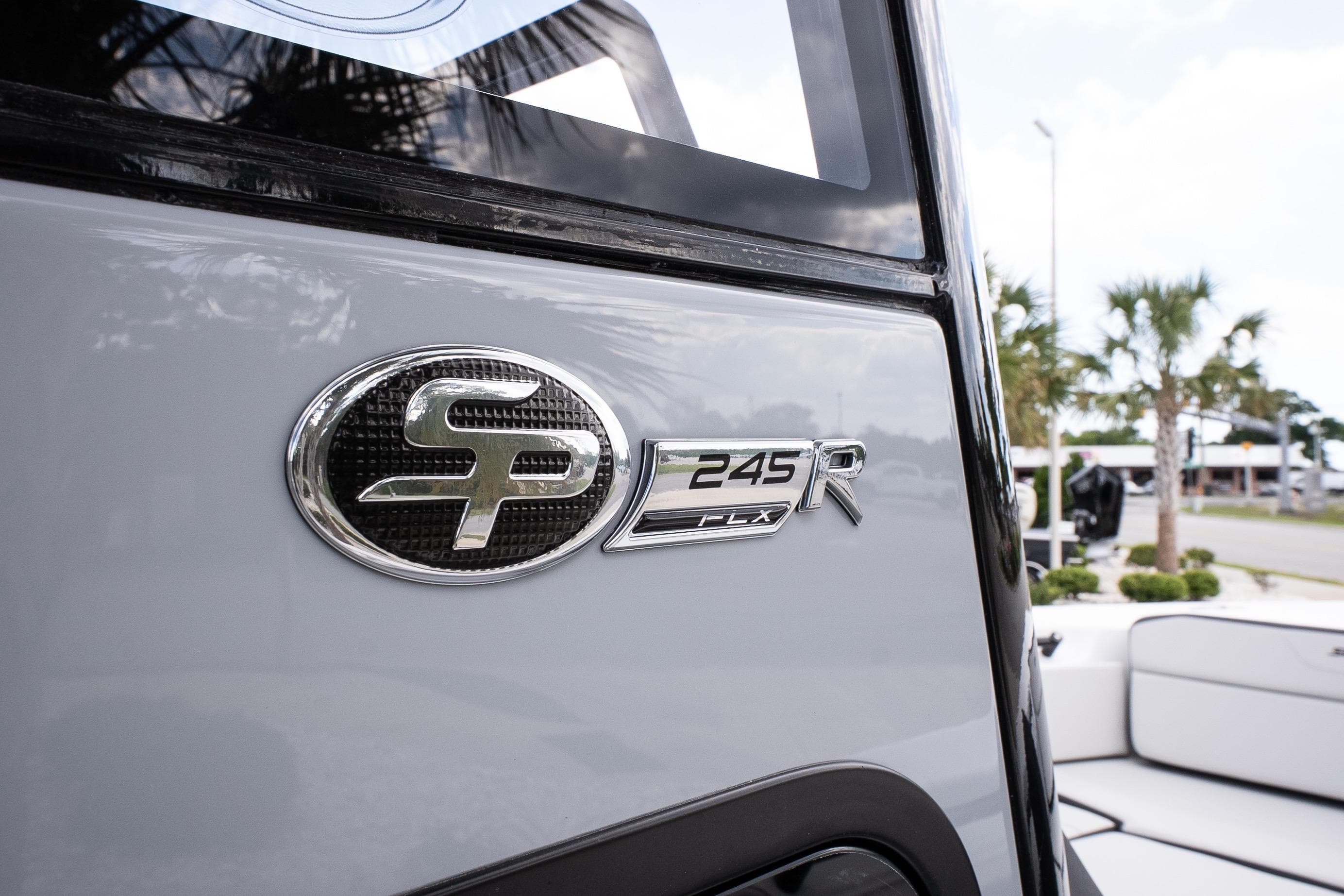 2026 Sea Pro 245FLXR Sandbar boat emblem with palm trees in the background.
