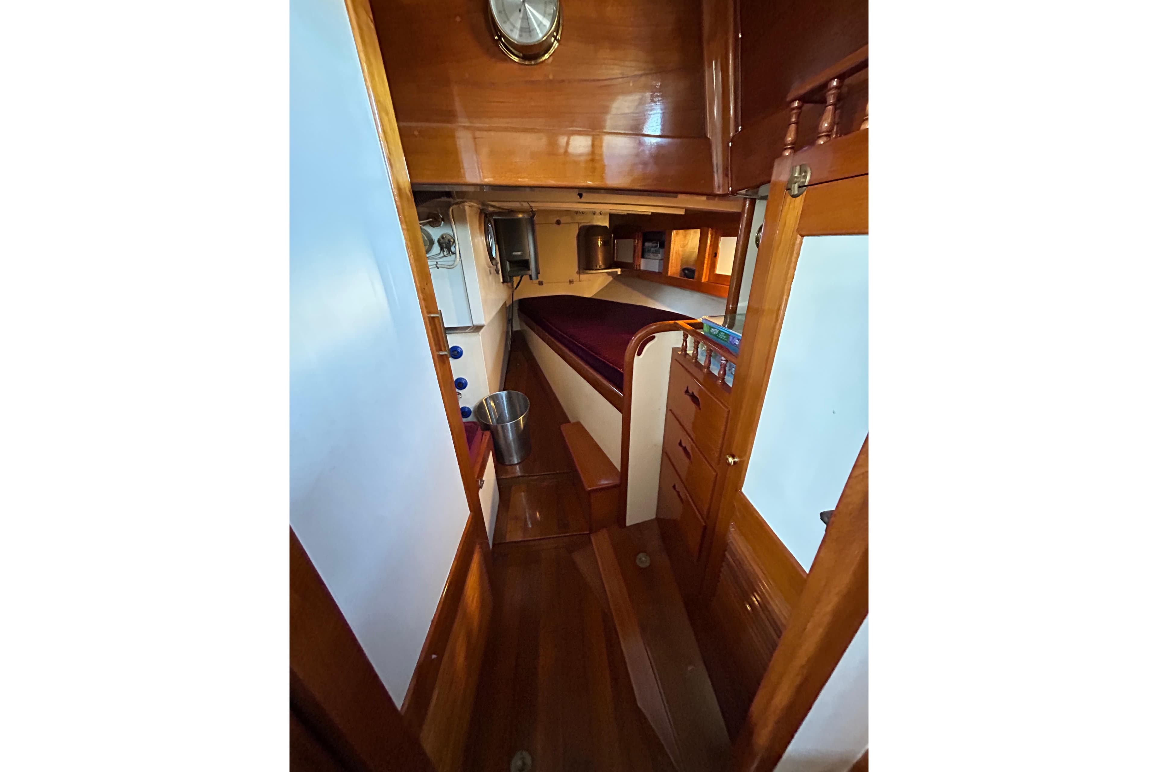 Interior of 1975 Robin Fong PORPOISE boat with wooden finishes and cozy cabin.
