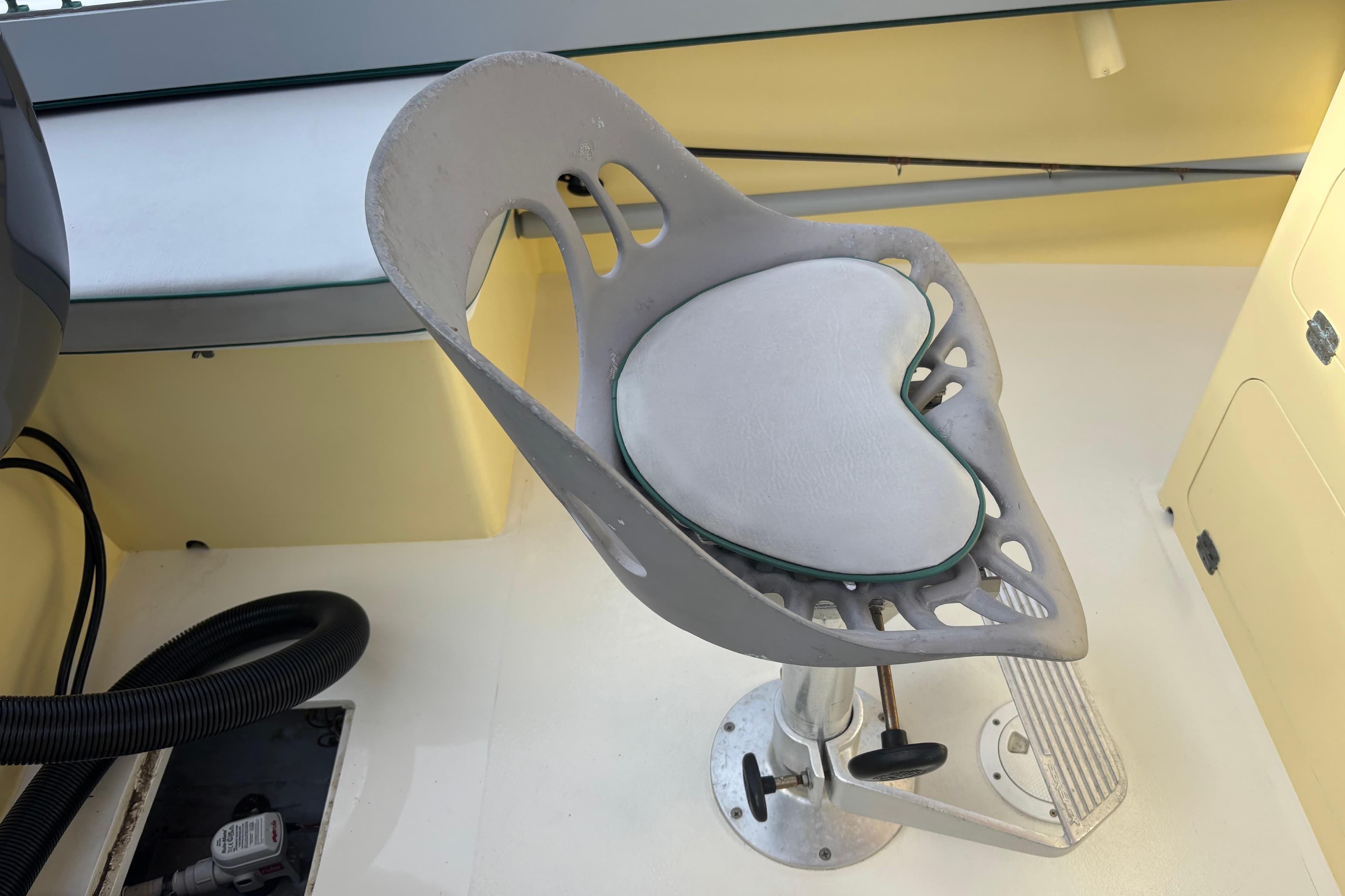 Adjustable boat seat with cushion on a Custom 20 model, 2005.