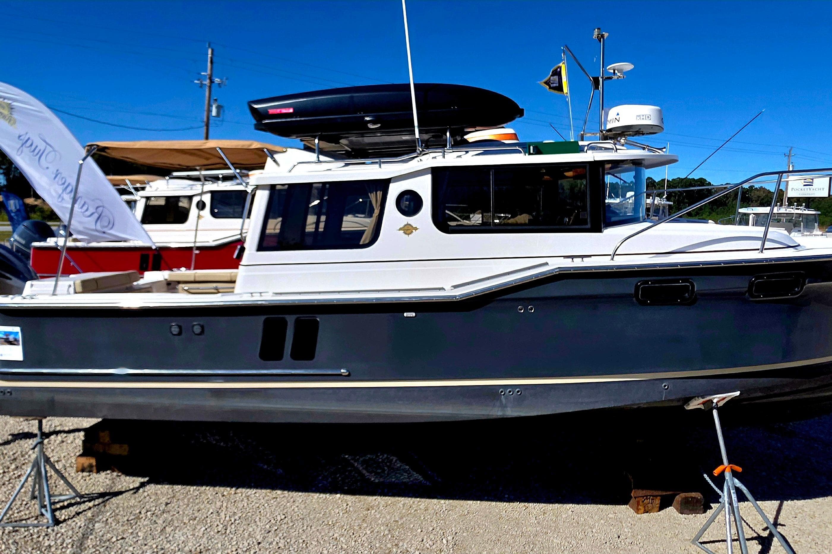 2020 Ranger Tugs R27LE boat displayed outdoors on a sunny day.