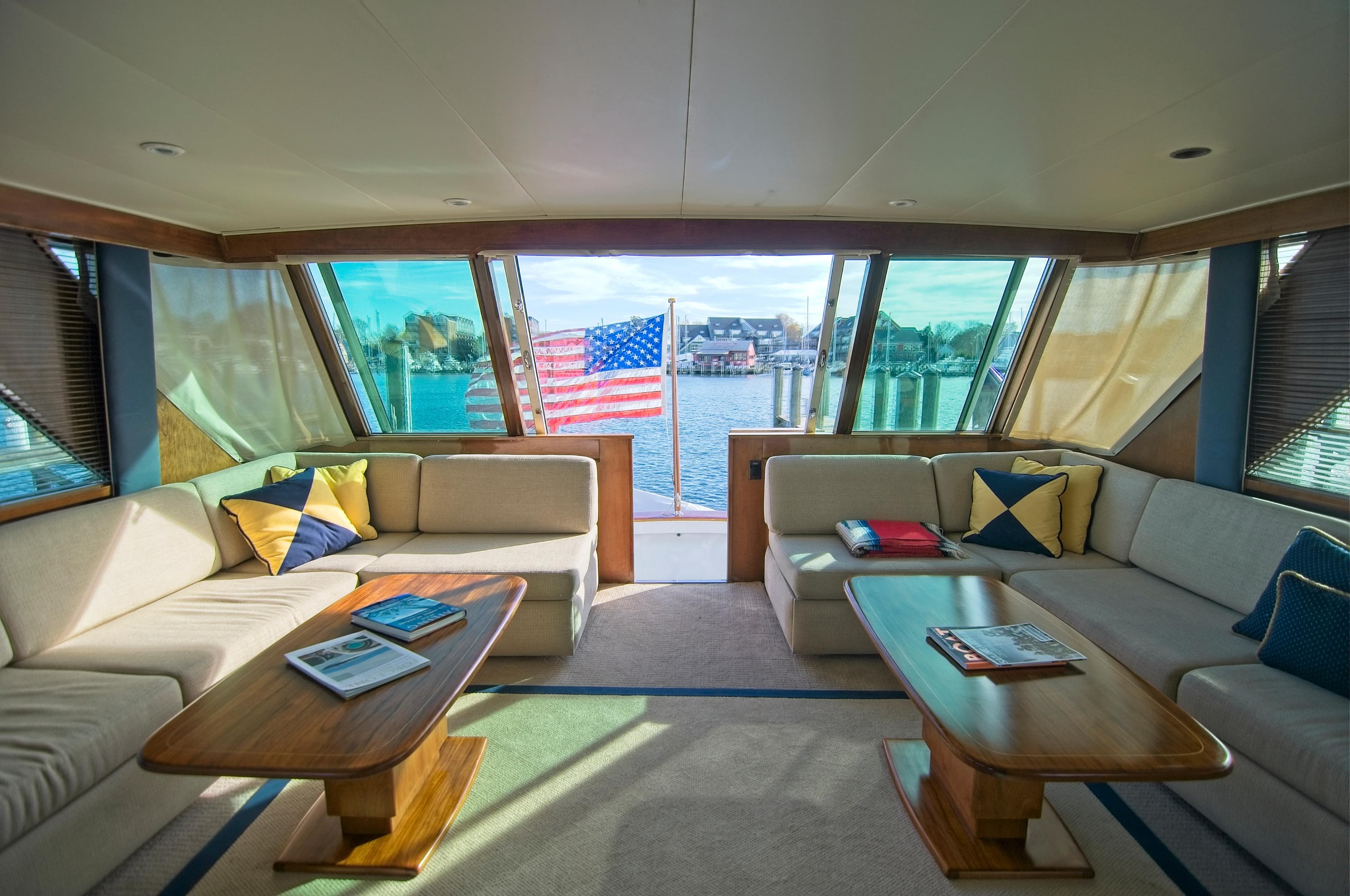 Luxurious 1982 Burger Flybridge yacht interior with comfortable seating and scenic water view.