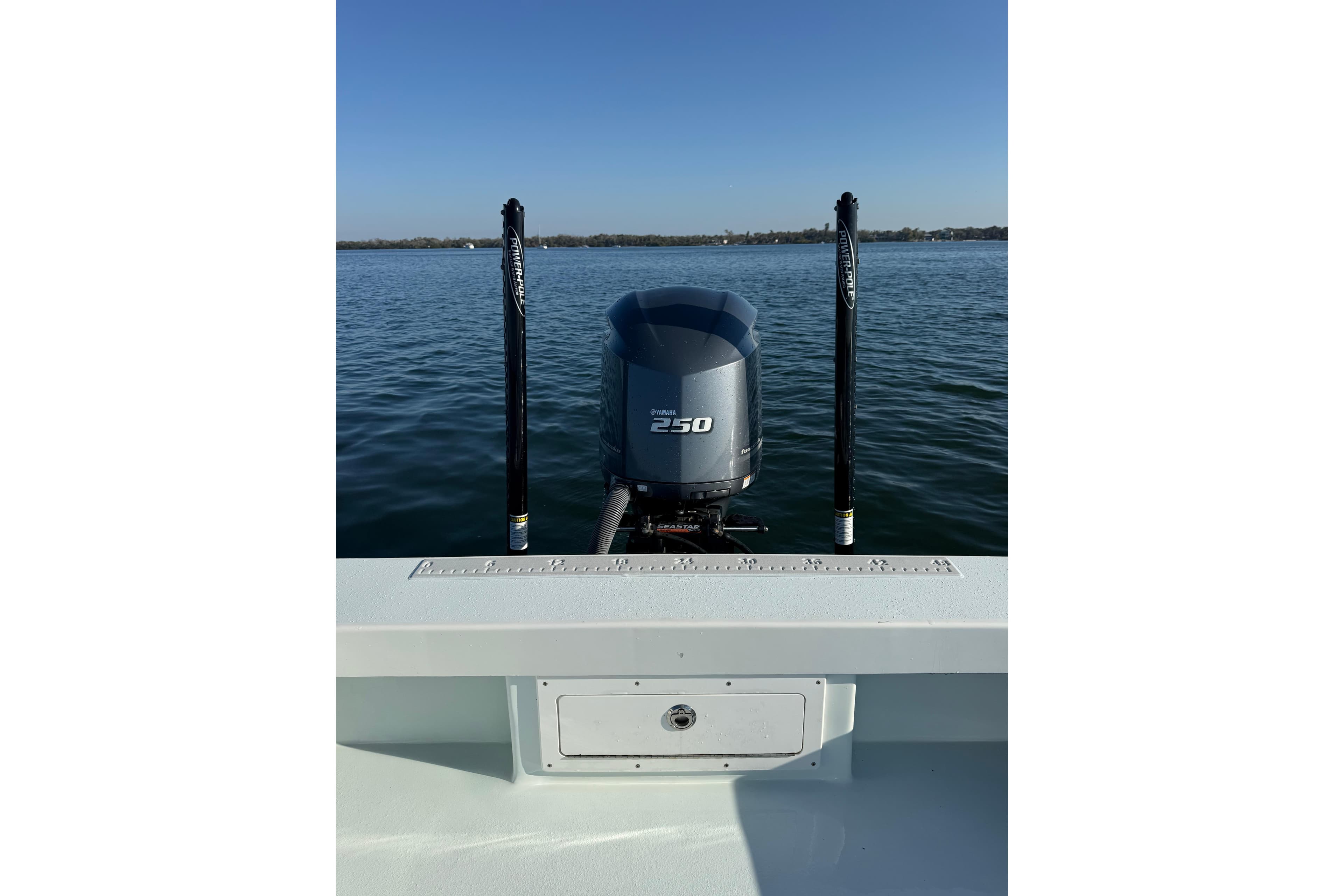 1987 Privateer 22 Roamer boat with 250 horsepower engine on calm water.