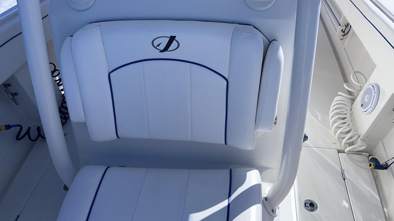 2017 Jupiter 32 Cuddy Cabin boat seat with logo, white upholstery.