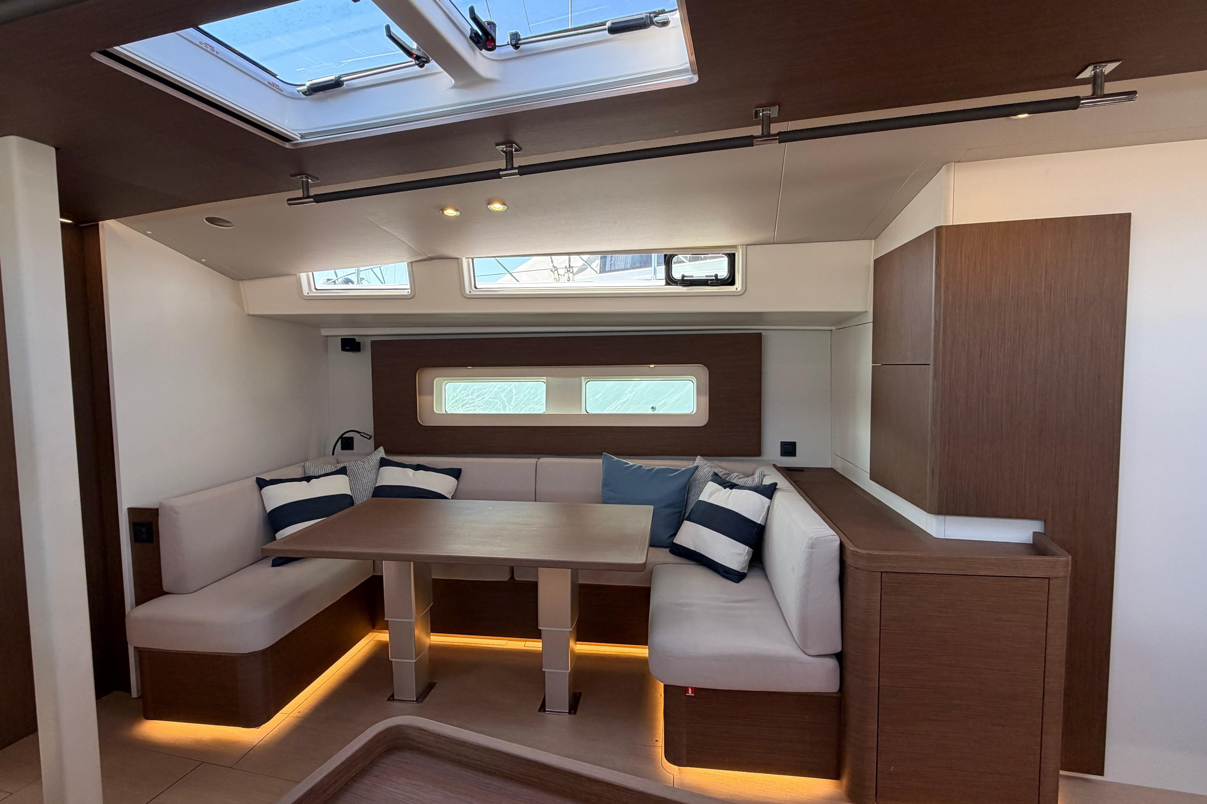 Luxurious interior of 2022 Beneteau Oceanis Yacht 54 with elegant seating and modern design.