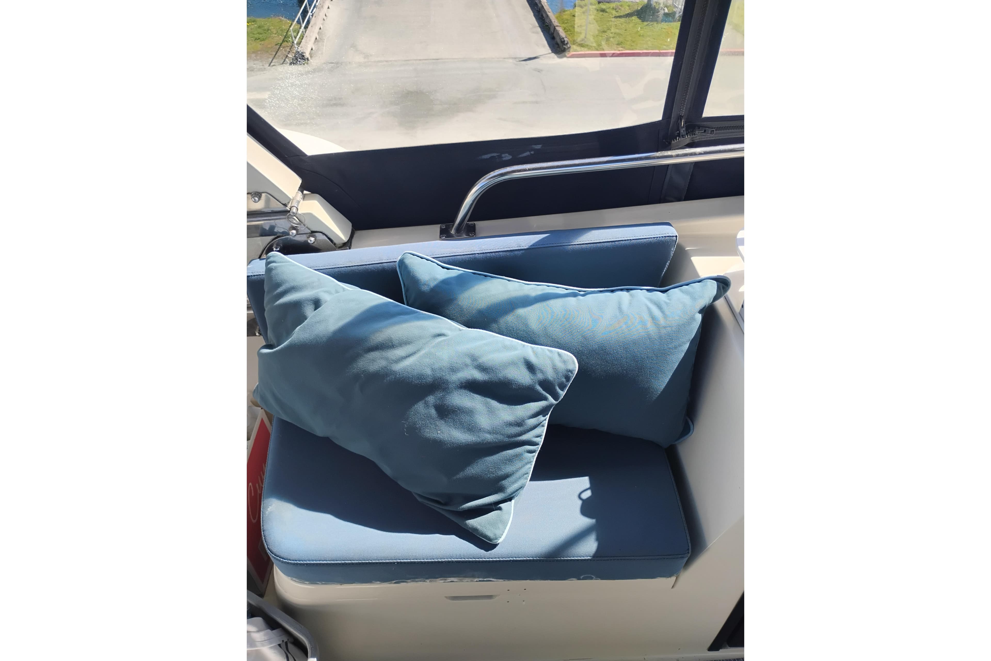 Blue cushioned seating area on 1988 PT 52 AFT Cabin Motor Yacht.