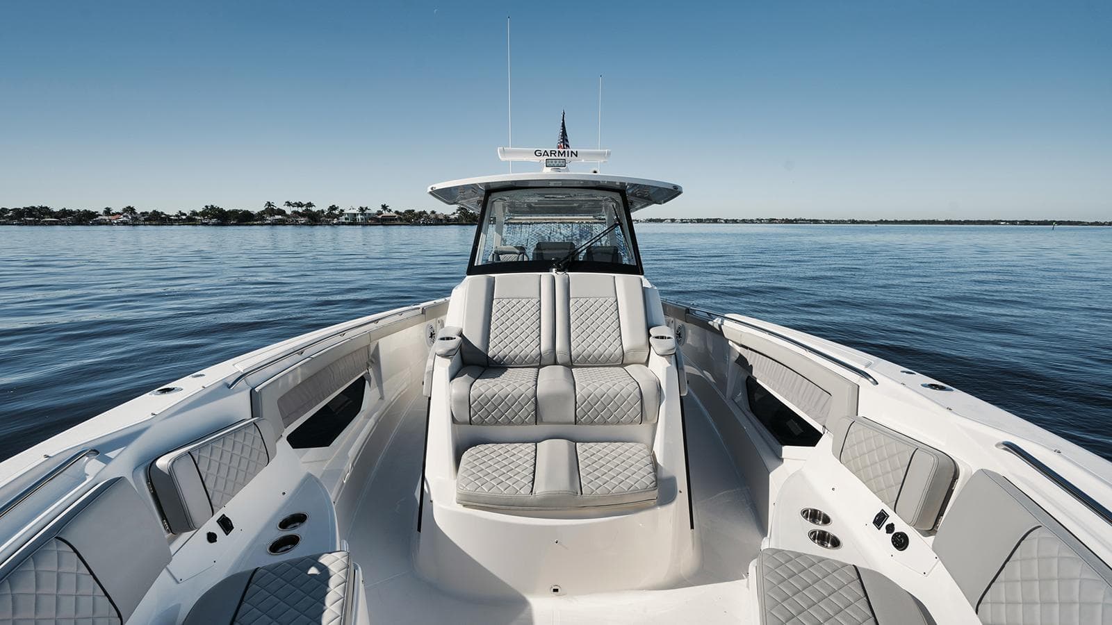 2022 Pursuit S-378 boat interior with luxurious seating on calm water.