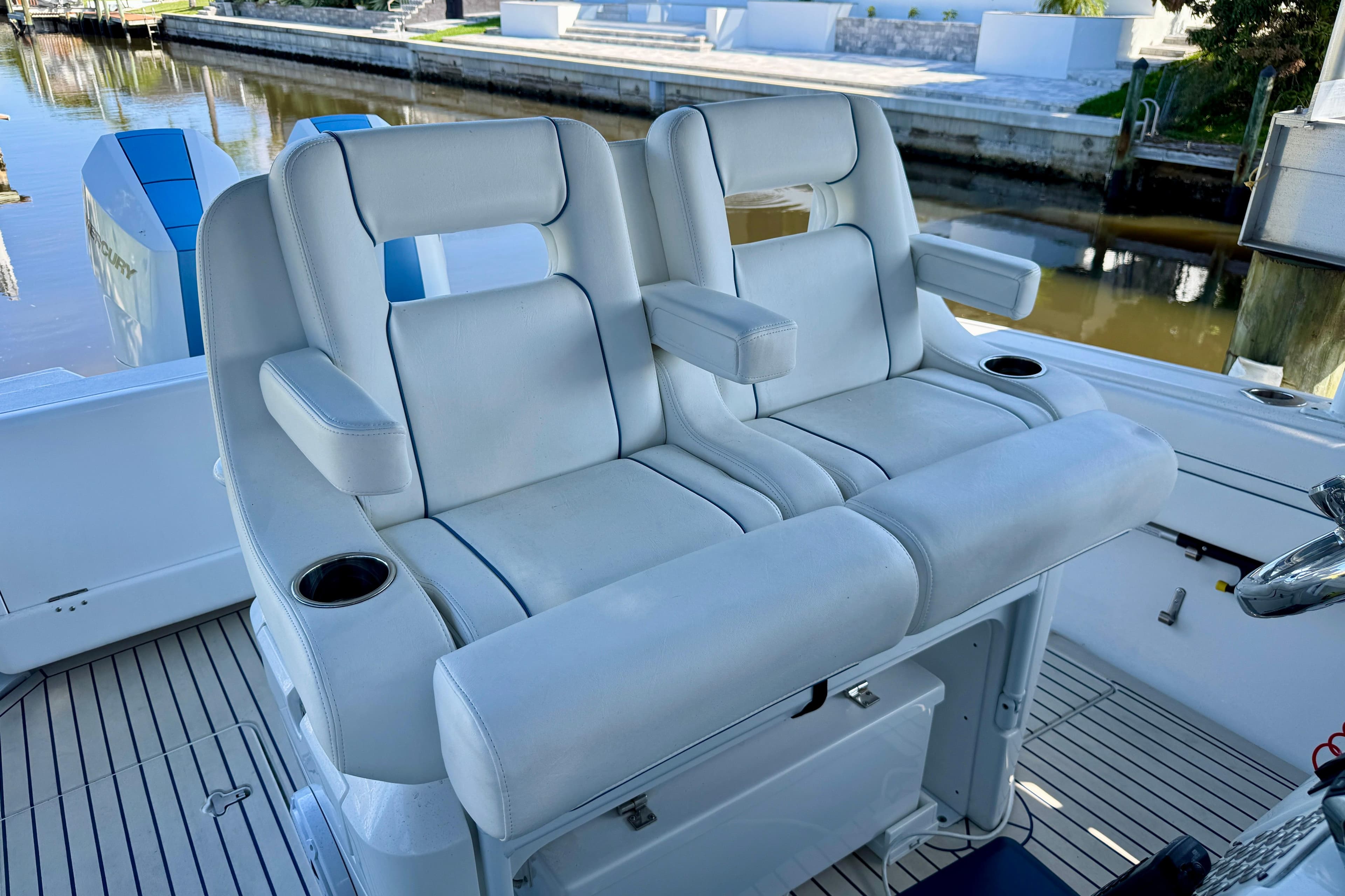 Luxury seating on 2025 Intrepid 327 Cuddy boat, featuring comfortable armrests and cup holders.