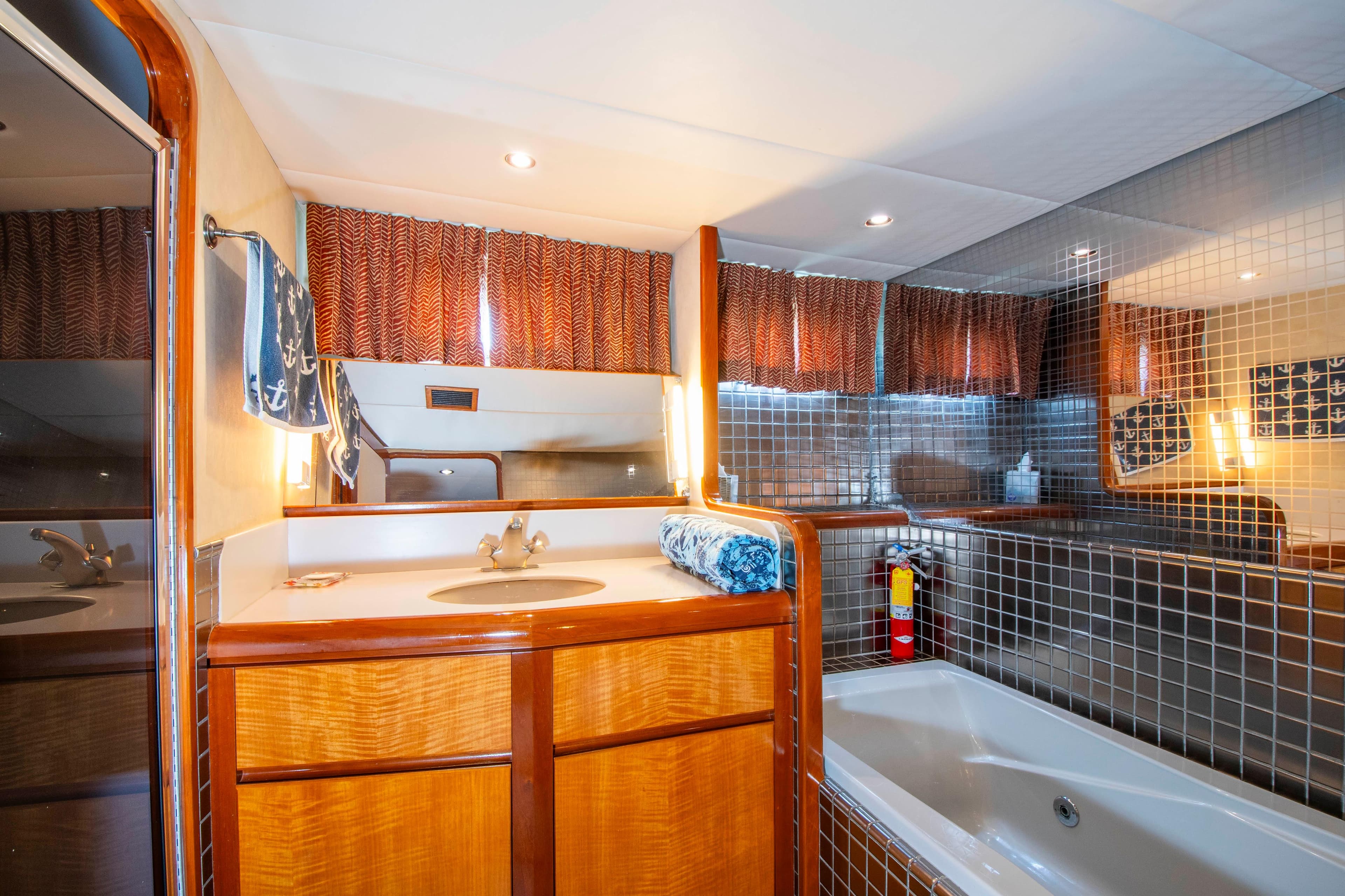 Luxurious bathroom in 1988 Knight & Carver motoryacht with wood cabinetry and modern fixtures.