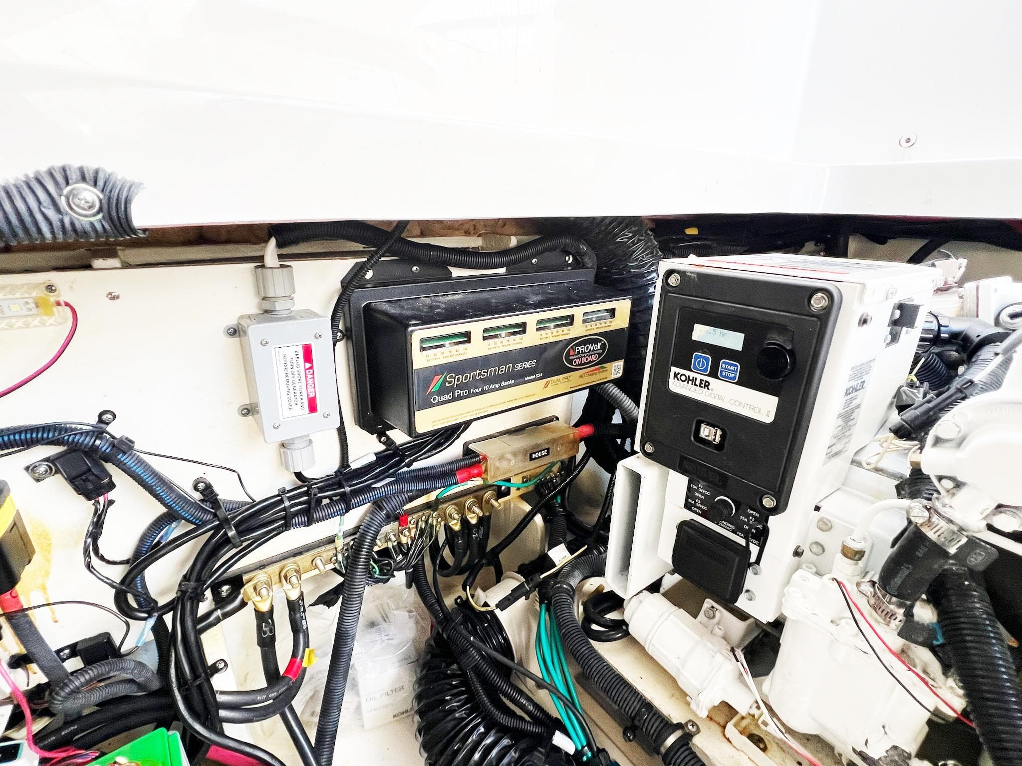 Engine compartment of 2019 Sea Ray Sundancer 320 Outboard with electrical components and wiring.