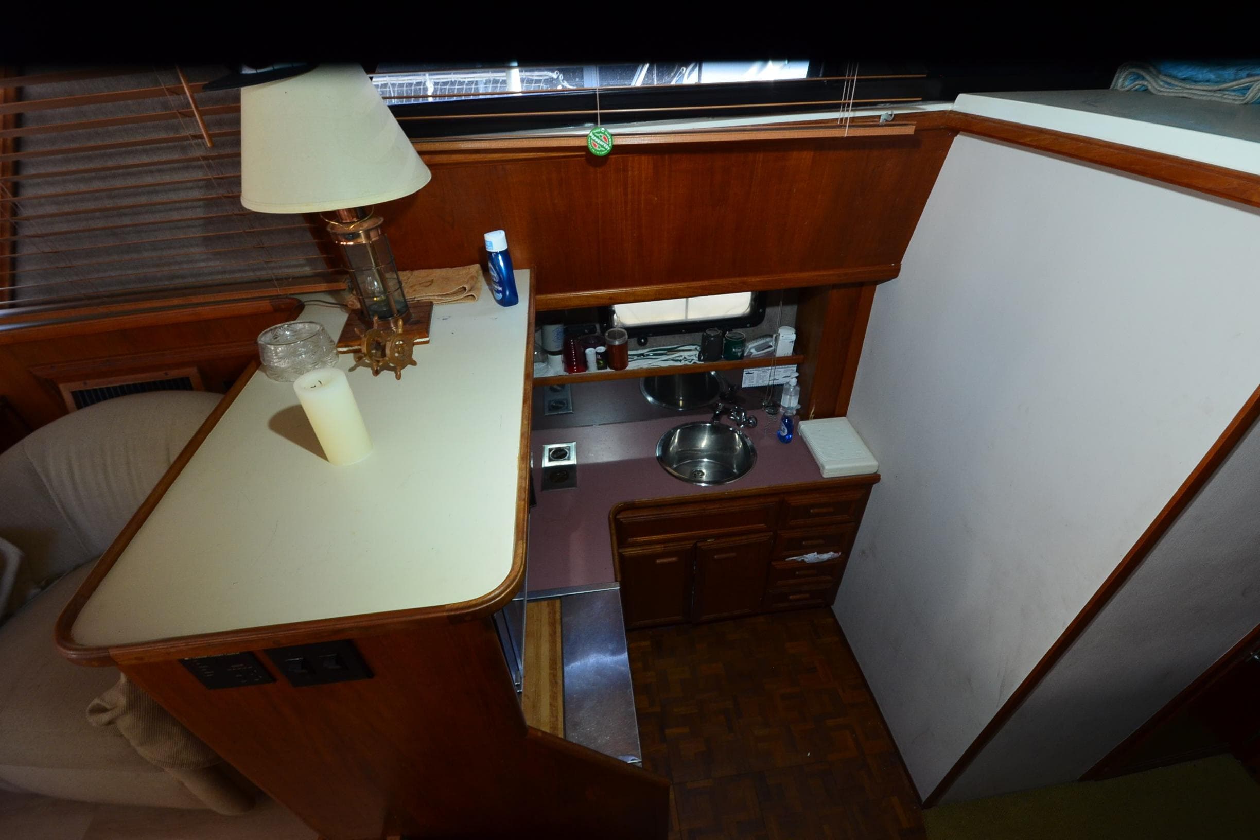 1986 Carver Cockpit 4227 MY interior with kitchenette and wooden cabinetry.