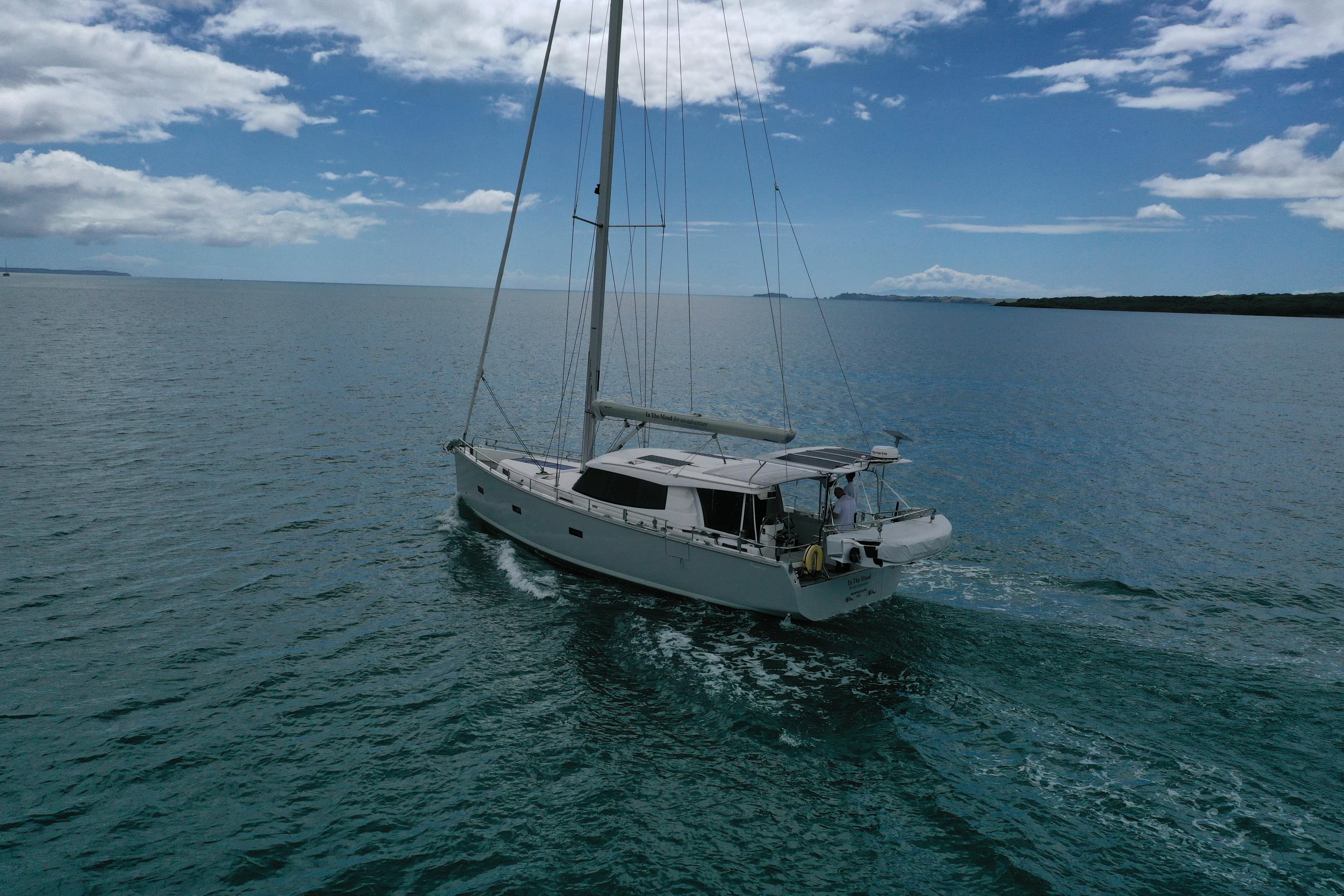 Sailing yacht Moody DS 45, 2011 model, cruising on calm ocean waters under a partly cloudy sky.