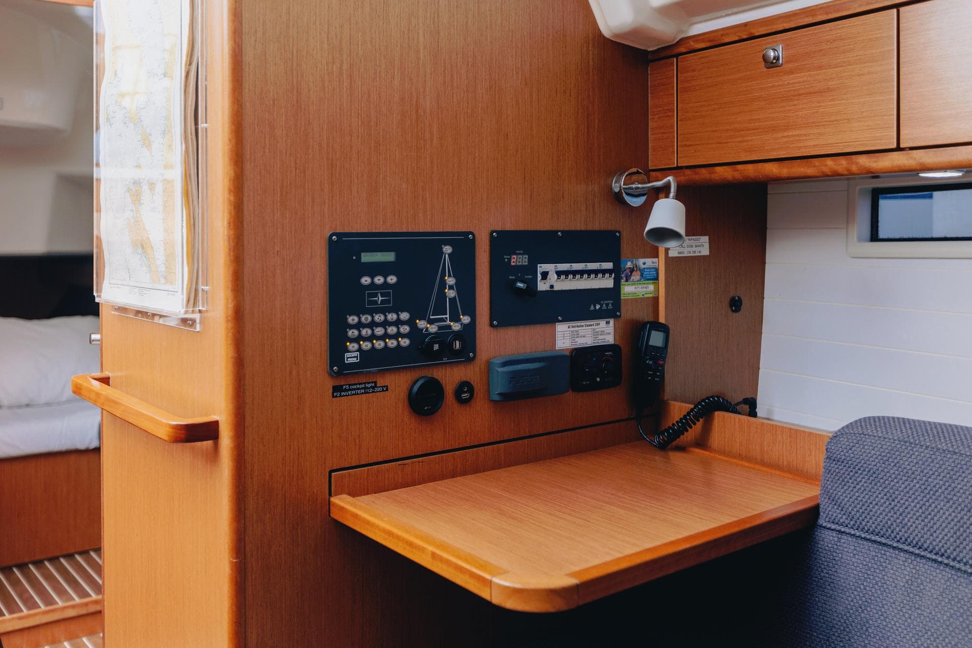 Interior of 2017 Bavaria 37 Cruiser yacht with navigation panel and wooden desk.
