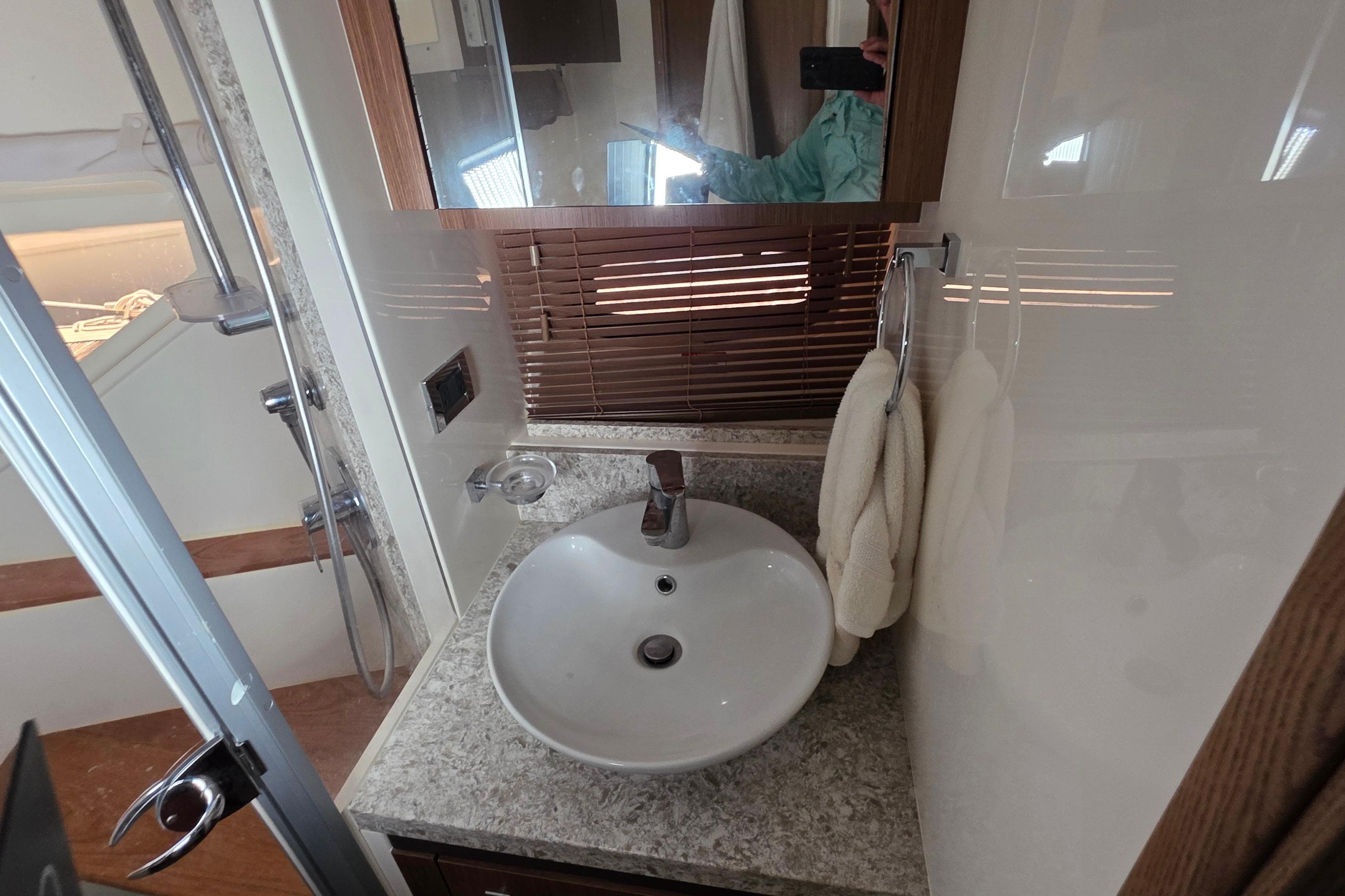 Bathroom interior of 2018 Sea Ray Sundancer 510 yacht with modern sink and shower.