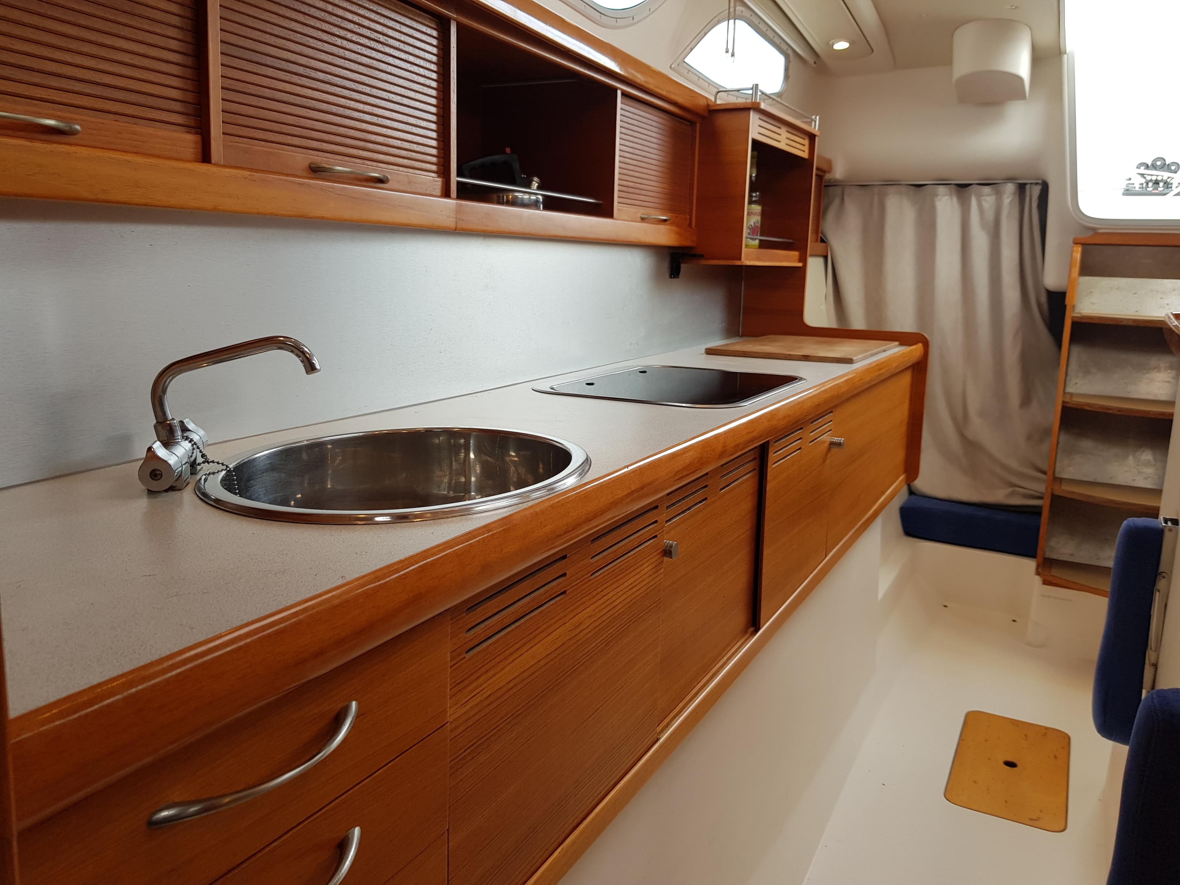 Interior of 2009 Dragonfly 35 Touring yacht with wooden cabinetry and modern kitchen amenities.