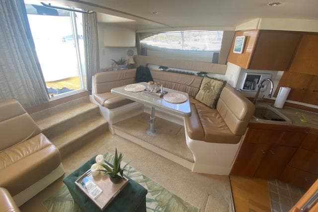 Interior of 2002 Carver 350 Mariner yacht with cozy seating and dining area.