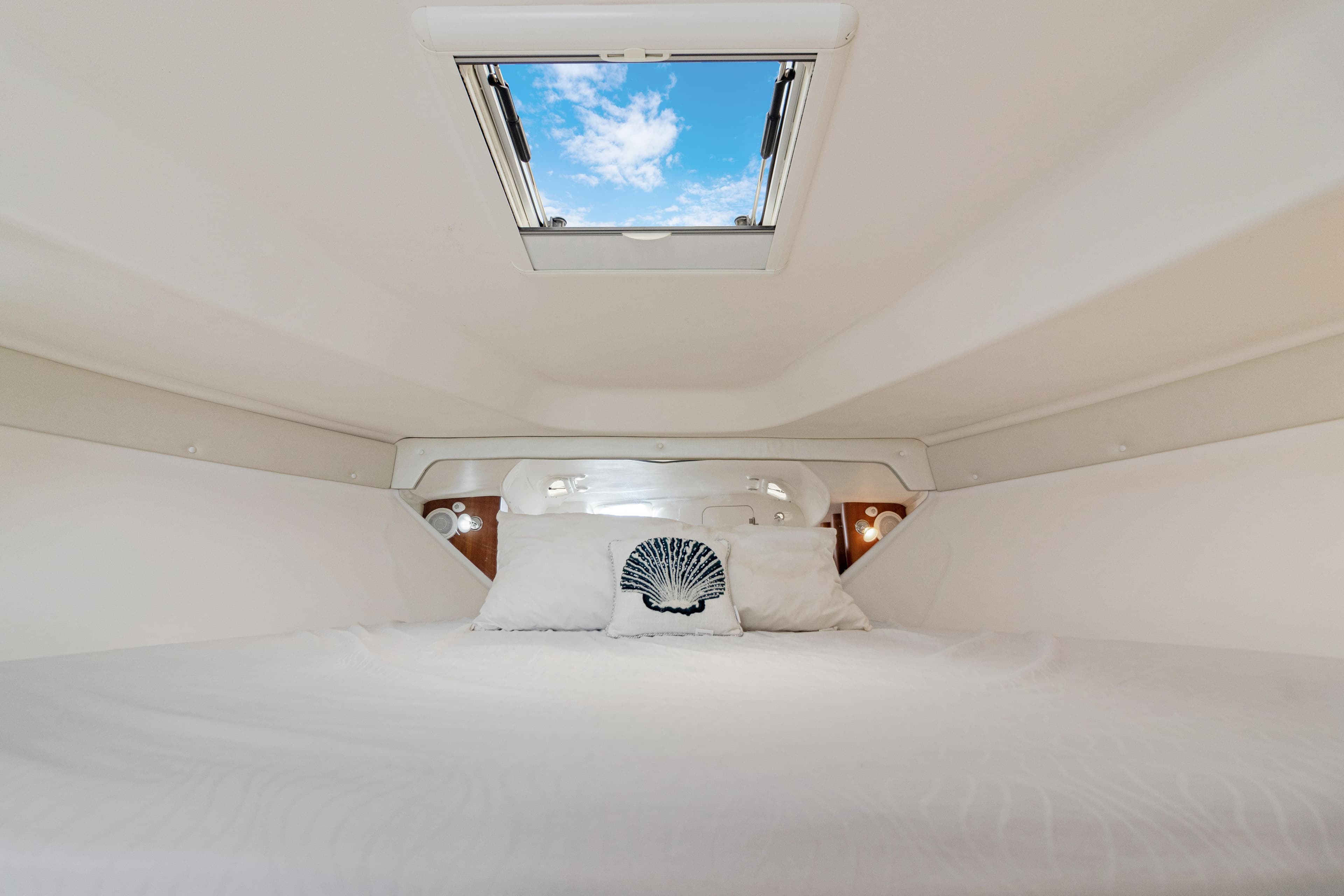 Interior cabin of 2004 Intrepid 377 Walkaround with skylight and bedding.