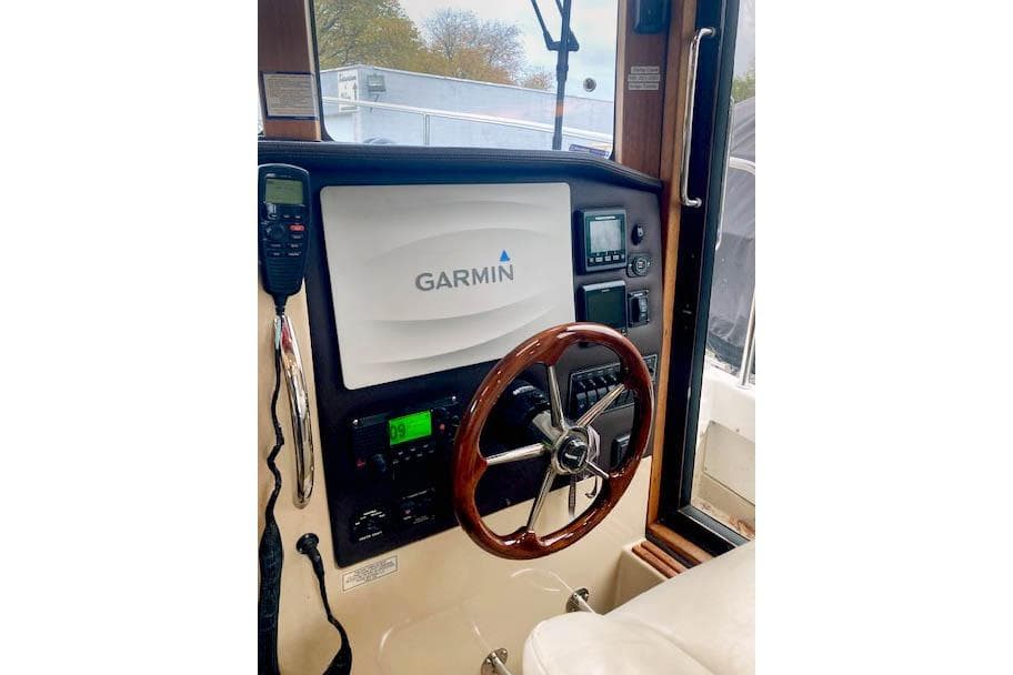 2016 Ranger Tugs R-31 helm with Garmin navigation system and wooden steering wheel.