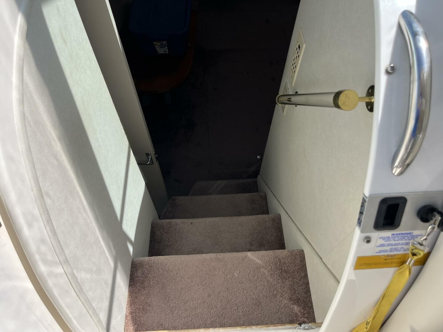 Stairway inside 1998 Cruisers Yachts 3870 Esprit, leading to lower cabin area.