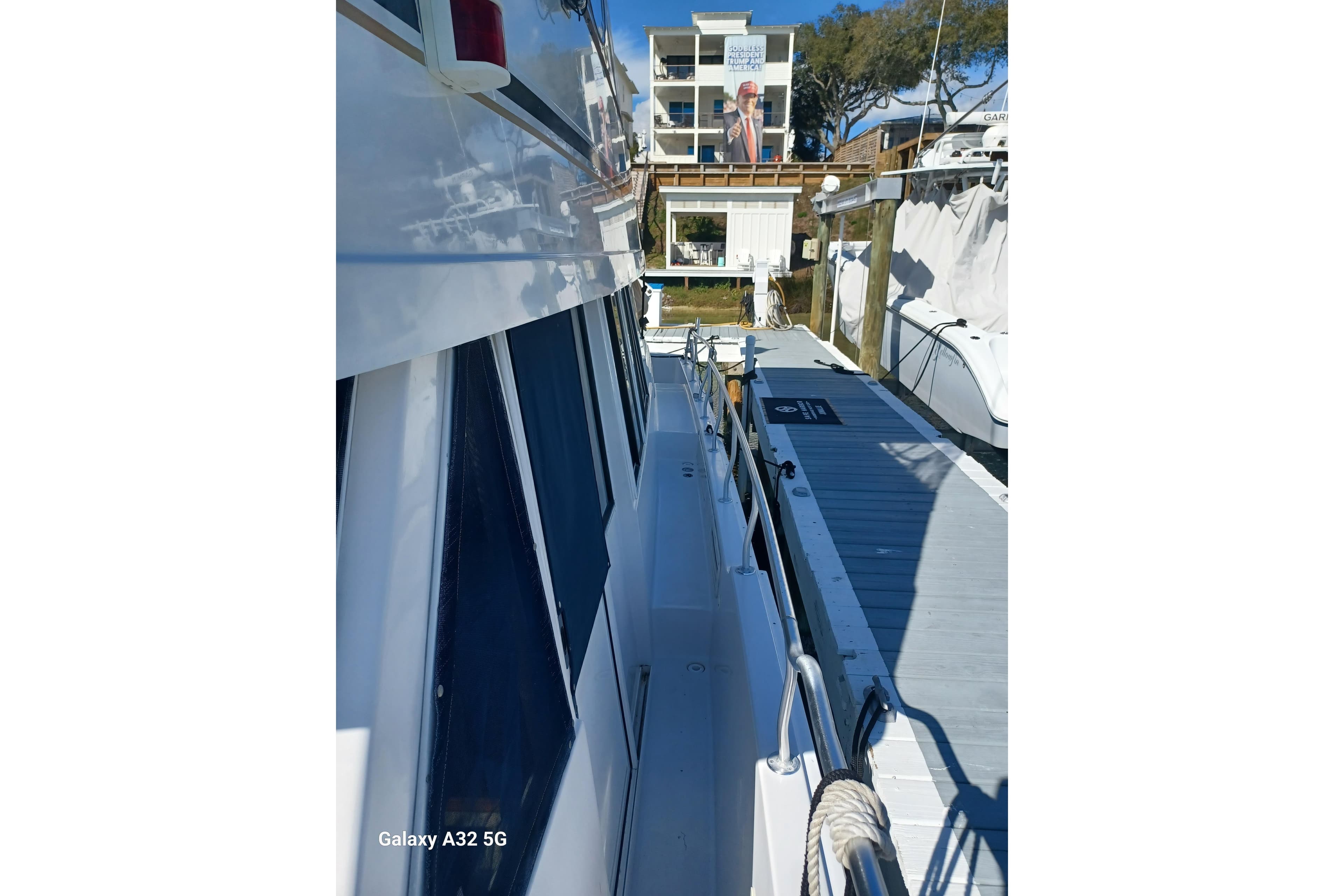 1999 Mainship 43 Trawler Aft Cabin docked at marina, side view.