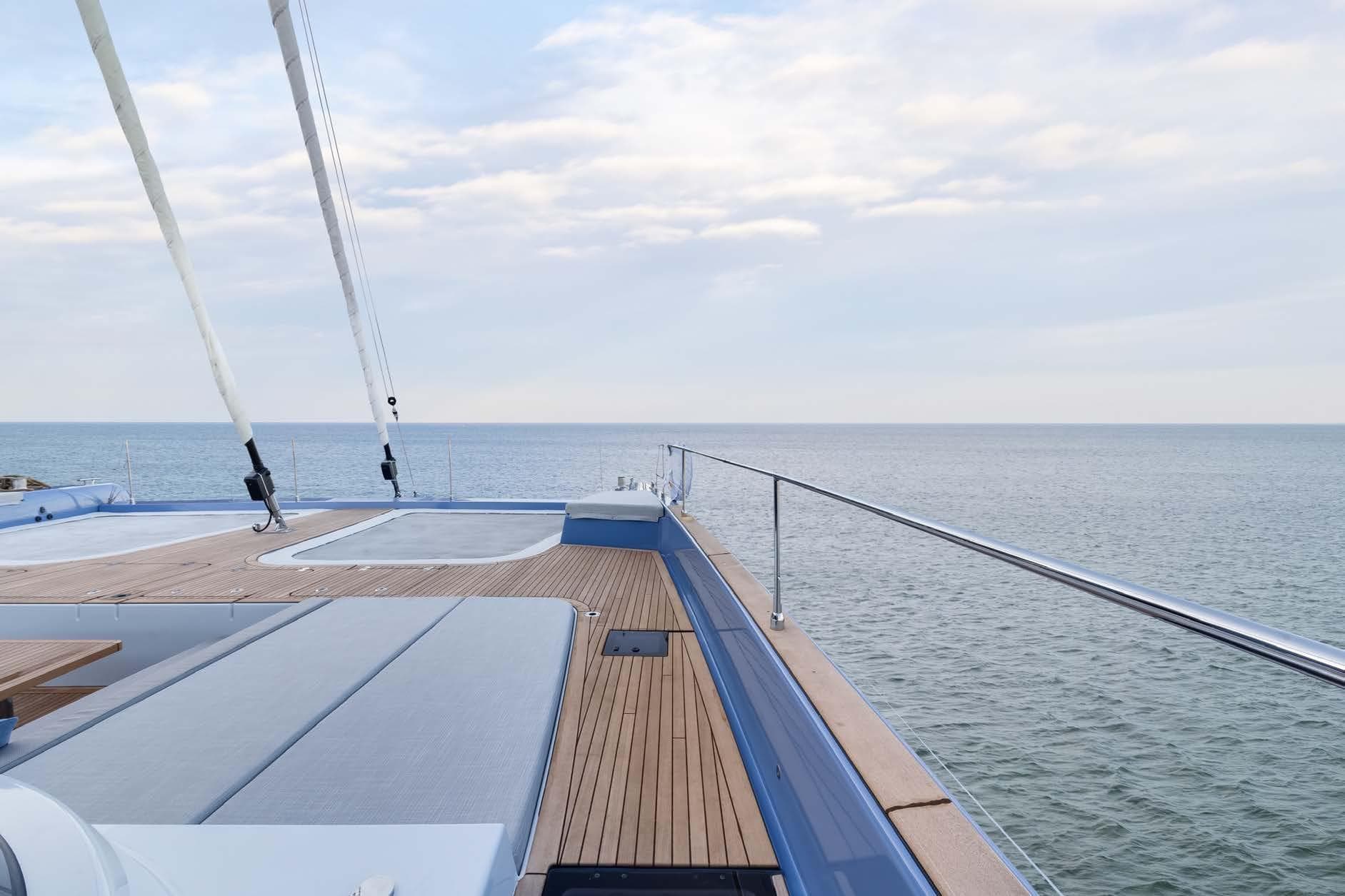 2023 Sunreef 70 Sailing yacht deck with ocean view and clear sky.