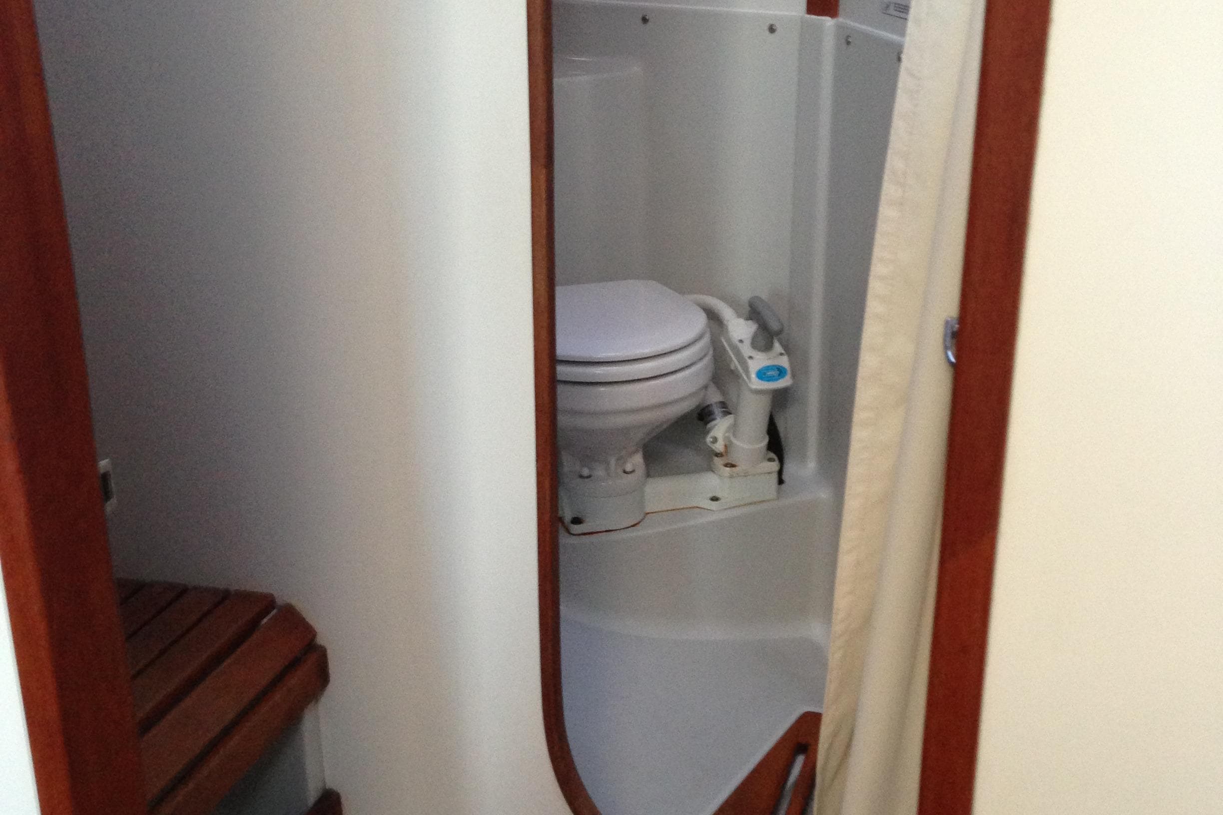 1989 J Boats J/44 yacht bathroom with toilet and wooden seat.