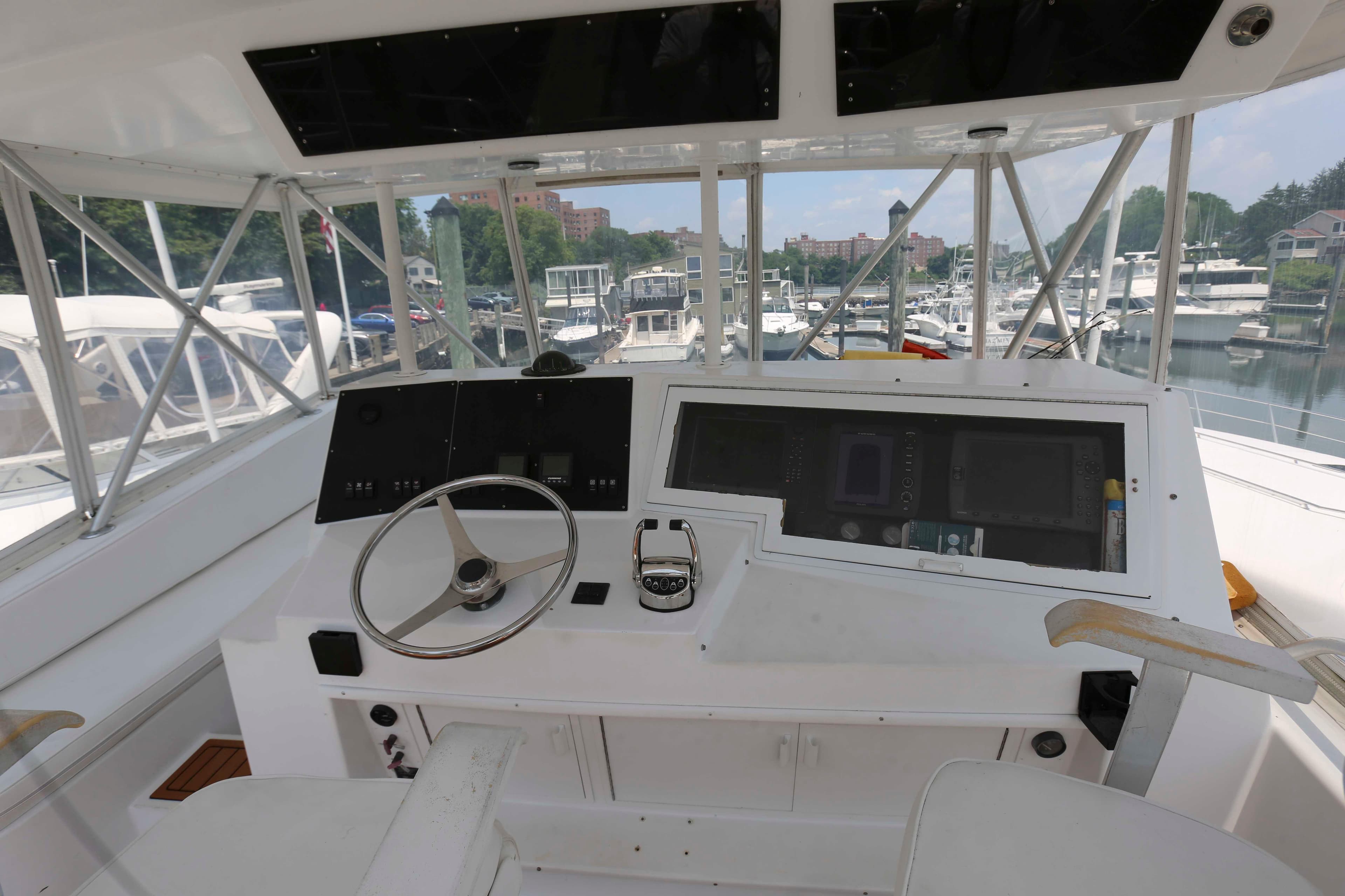 Cockpit of 1991 Viking 50 Convertible yacht with steering wheel and control panel.